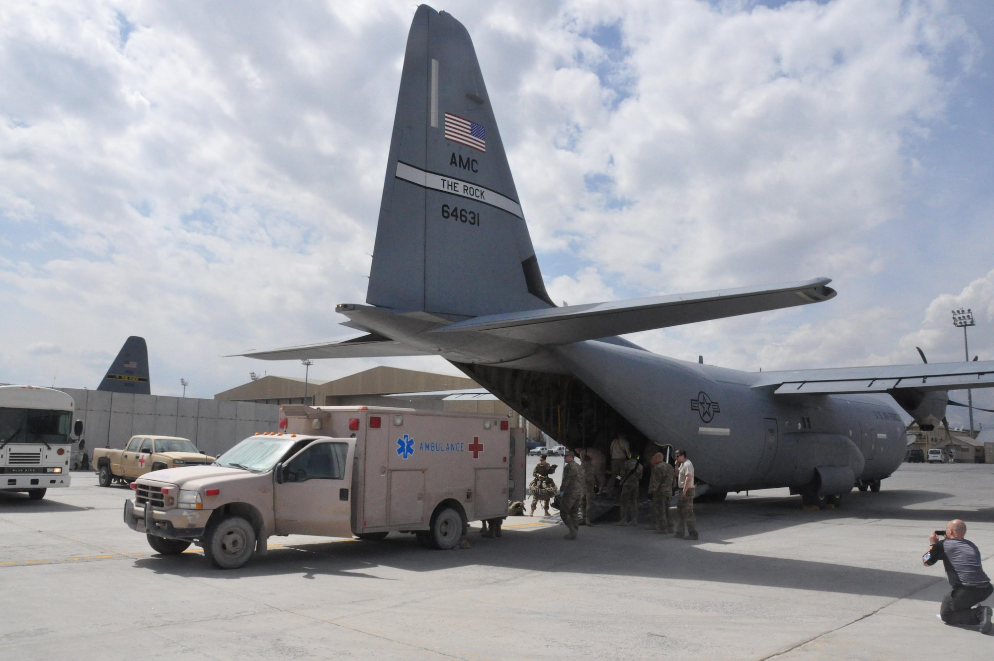 A patient is offloaded from a C-130J with the 772nd Expeditionary Airlift Squadron at Bagram Airfield, Afghanistan, April 7, 2013. The aircraft is met by an ambulance which will take the patient to Craig Joint Theater Hospital. This is the same procedure that was used during an Aeromedical Evacuation mission to move a critically wounded combat controller from Mazar-e Sharif, in northern Afghanistan, to more advanced medical care at the hospital at Bagram in late March. (U.S. Air Force photo/Capt. Tristan Hinderliter)