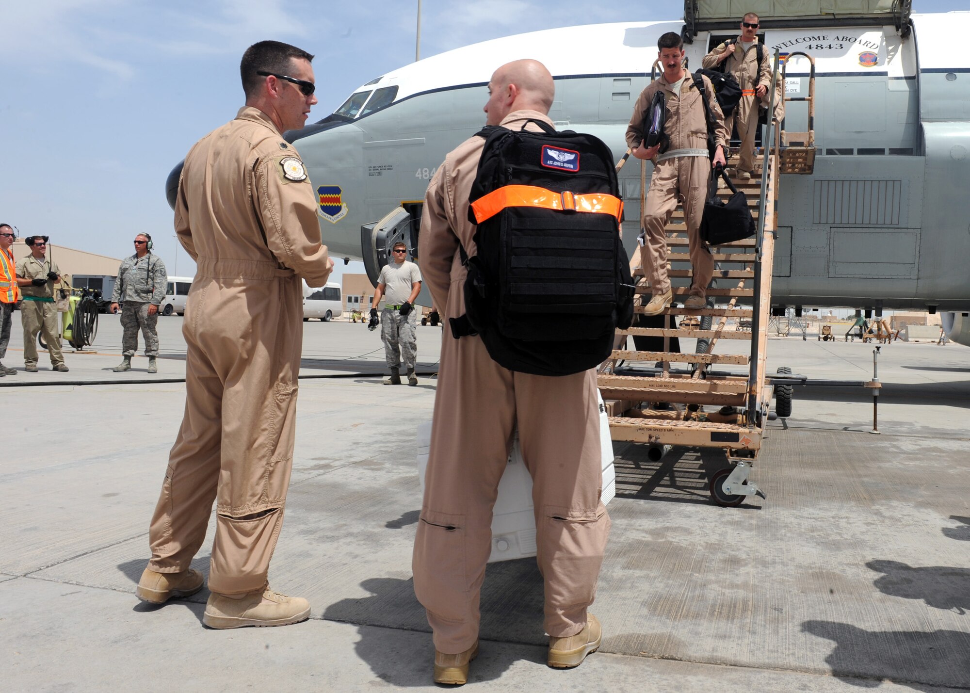 SOUTHWEST ASIA -  Lt. Col. Sean Coveney, 763rd Expeditionary Reconnaissance Squadron commander, congratulates  Airman 1st Class John Griffin, 763rd ERS aircrew, for being part of the crew which completed the squadron’s 10,000th expeditionary sortie, April 10. The commander also gave each crewmember a coin to commemorate the milestone.  The squadron has been continuously deployed to the U.S. Central Command area of responsibility for nearly 23 years. (U.S. Air Force photo/Staff Sgt. Joel Mease)
