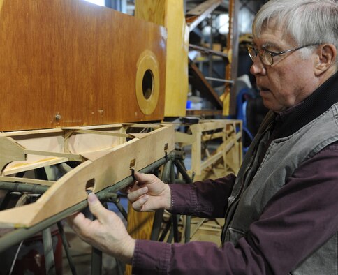 Gary White, Waco glider restoration project volunteer, places a part onto the body of a Waco CG-4A glider at Whiteman Air Force Base, Mo., April 2, 2013. All restorations done on the aircraft have been completed by an all-volunteer force. (U.S. Air Force photo by Airman 1st Class Bryan Crane/Released)
