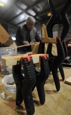 Gary White, Waco glider restoration project volunteer, glues pieces of wood together and lets them dry at Whiteman Air Force Base, Mo., April 2, 2013. The U.S. Army Air Corps stopped production of the Waco CG-4A glider at the end of World War II. (U.S. Air Force photo by Airman 1st Class Bryan Crane/Released)