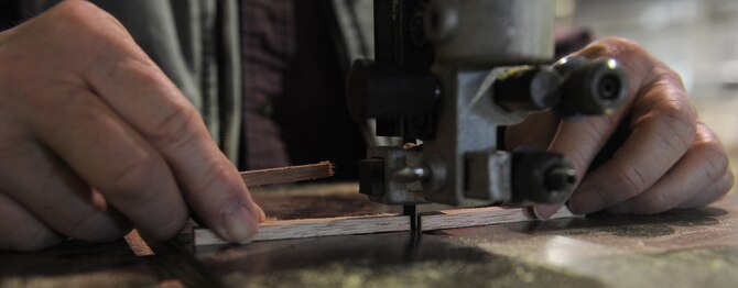 Gary White, Waco glider restoration project volunteer, cuts a piece of wood to measurement at Whiteman Air Force Base, Mo., April 2, 2013. Volunteers began restoring the Waco CG-4A glider in 2006. (U.S. Air Force photo by Airman 1st Class Bryan Crane/Released)