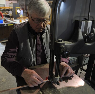 Gary White, Waco glider restoration project volunteer, cuts a piece of wood to measurement at Whiteman Air Force Base, Mo., April 2, 2013. The Waco CG-4A glider being restored on base belongs to the Air Force Museum. (U.S. Air Force photo by Airman 1st Class Bryan Crane/Released)