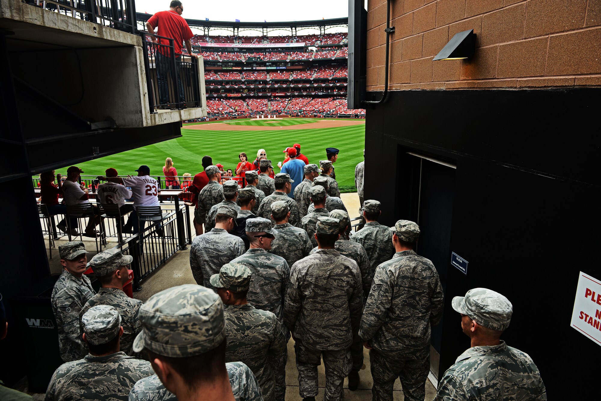Airmen from the 375th Air Mobility Wing, Scott Air Force Base, Ill., make their way to the field at Busch Stadium, home of the St. Louis Cardinals, to present the giant flag for nearly 50,000 fans to see April 8, 2013. Scott AFB has been involved in numerous community sporting events, but this was the first time they presented the flag at the opening day of the season. The Cardinals went on to lose to the Cincinnati Reds 13-4. (U.S. Air Force photo/ Staff Sgt. Ryan Crane)