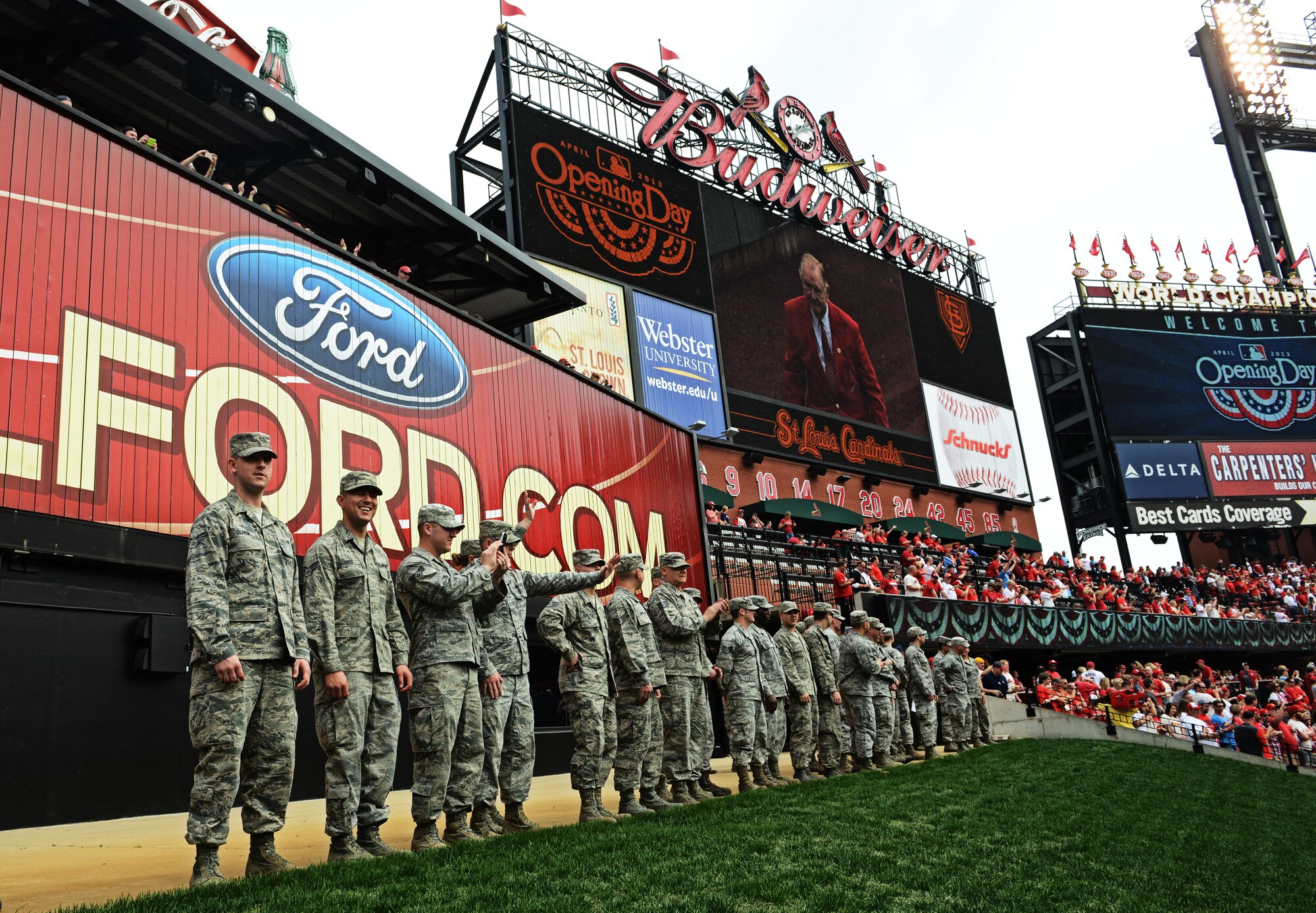 Airmen from the 375th Air Mobility Wing, Scott Air Force Base, Ill., get in position at Busch Stadium, home of the St. Louis Cardinals, to present the giant flag for nearly 50,000 fans to see April 8, 2013. Scott AFB has been involved in numerous community sporting events, but this was the first time they presented the flag at the opening day of the season. The Cardinals went on to lose to the Cincinnati Reds 13-4. (U.S. Air Force photo/ Staff Sgt. Ryan Crane)