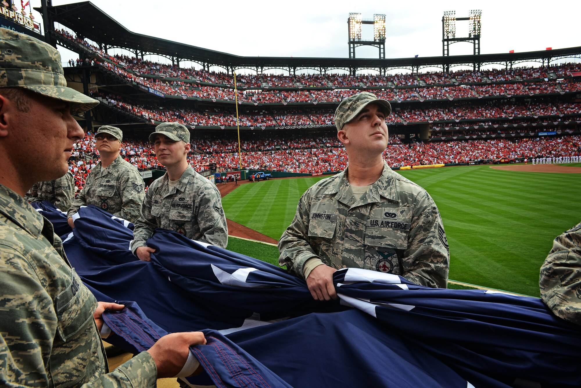 Staff Sgt. Christopher Johnston, 375th Civil Engineer Squadron firefighter from Scott Air Force Base, Ill., takes in the scene at Busch Stadium, home of the St. Louis Cardinals, as he and his fellow Airmen present the giant flag for nearly 50,000 fans to see April 8, 2013. Scott AFB has been involved in numerous community sporting events, but this was the first time they presented the flag at the opening day of the season. The Cardinals went on to lose to the Cincinnati Reds 13-4. (U.S. Air Force photo/ Staff Sgt. Ryan Crane)