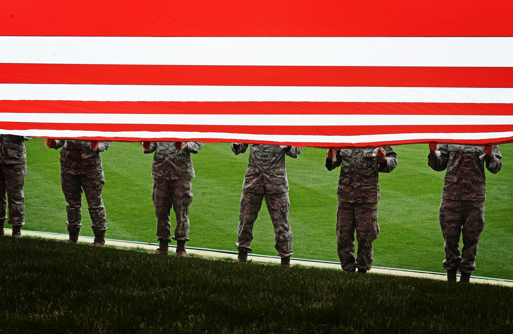 Airmen from the 375th Air Mobility Wing, Scott Air Force Base, Ill., present the giant American flag for nearly 50,000 fans to see at Busch Stadium, home of the St. Louis Cardinals, April 8, 2013. Scott AFB has been involved in numerous community sporting events, but this was the first time they presented the flag at the opening day of the season. The Cardinals went on to lose to the Cincinnati Reds 13-4. (U.S. Air Force photo/ Staff Sgt. Ryan Crane)