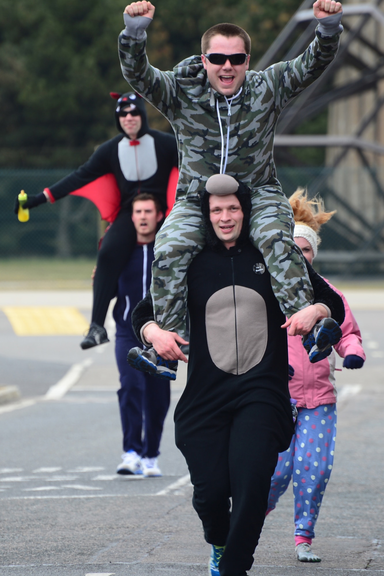 ROYAL AIR FORCE LAKENHEATH, England -- Airmen from the 48th Civil Engineering Squadron explosive ordnance disposal flight cross the finish line during RAF Lakenheath's 3rd Annual Phil Myers Memorial 5K April 4, 2013. More than 150 Airmen, friends and family came out to support the event.  (U.S. Air Force photo by Airman 1st Class Dana J. Butler)