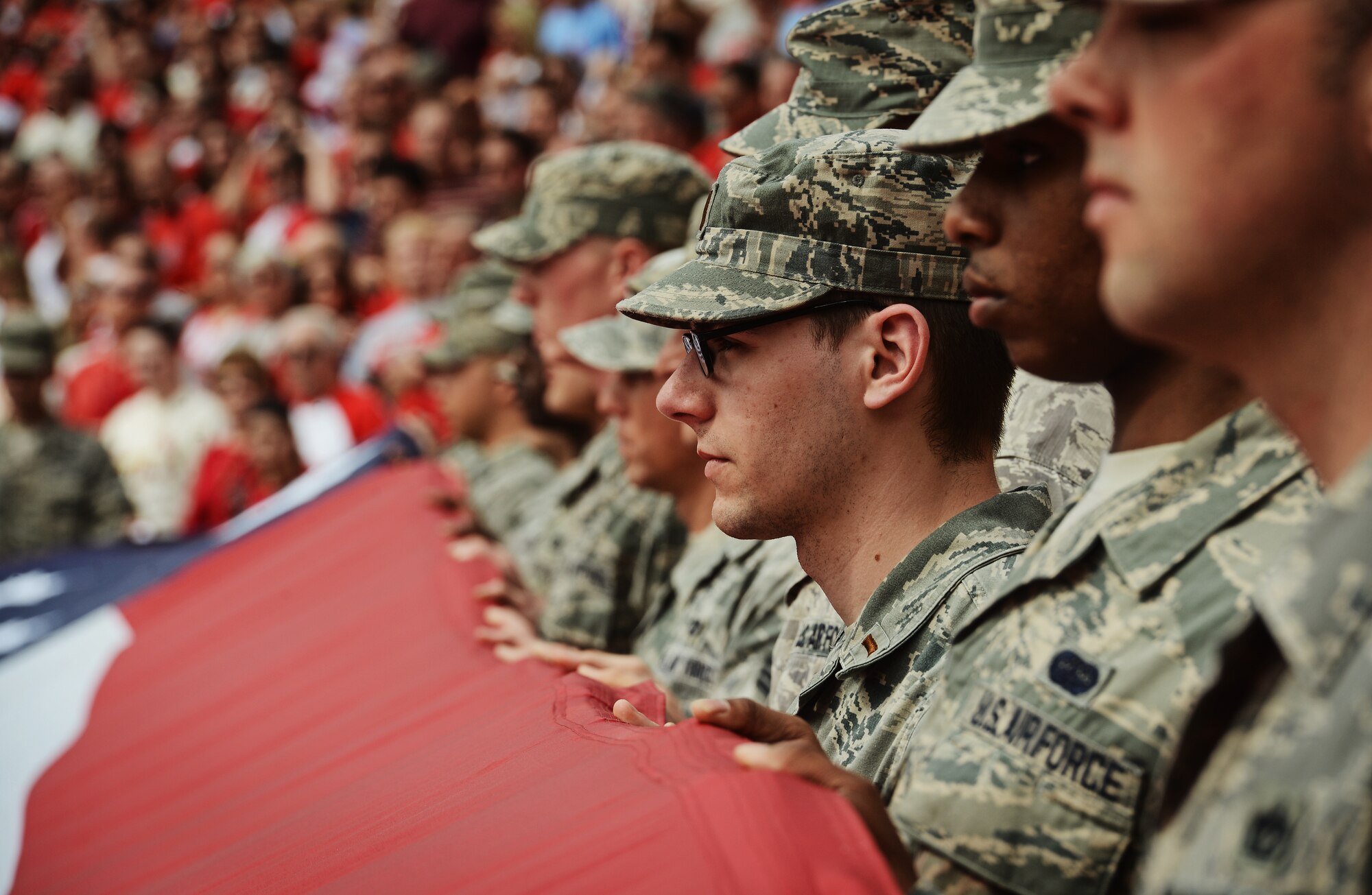 Airmen from the 375th Air Mobility Wing, Scott Air Force Base, Ill., present the giant American flag for nearly 50,000 fans to see at Busch Stadium, home of the St. Louis Cardinals, April 8, 2013. Scott AFB has been involved in numerous community sporting events, but this was the first time they presented the flag at the opening day of the season. The Cardinals went on to lose to the Cincinnati Reds 13-4. (U.S. Air Force photo/ Staff Sgt. Ryan Crane) 