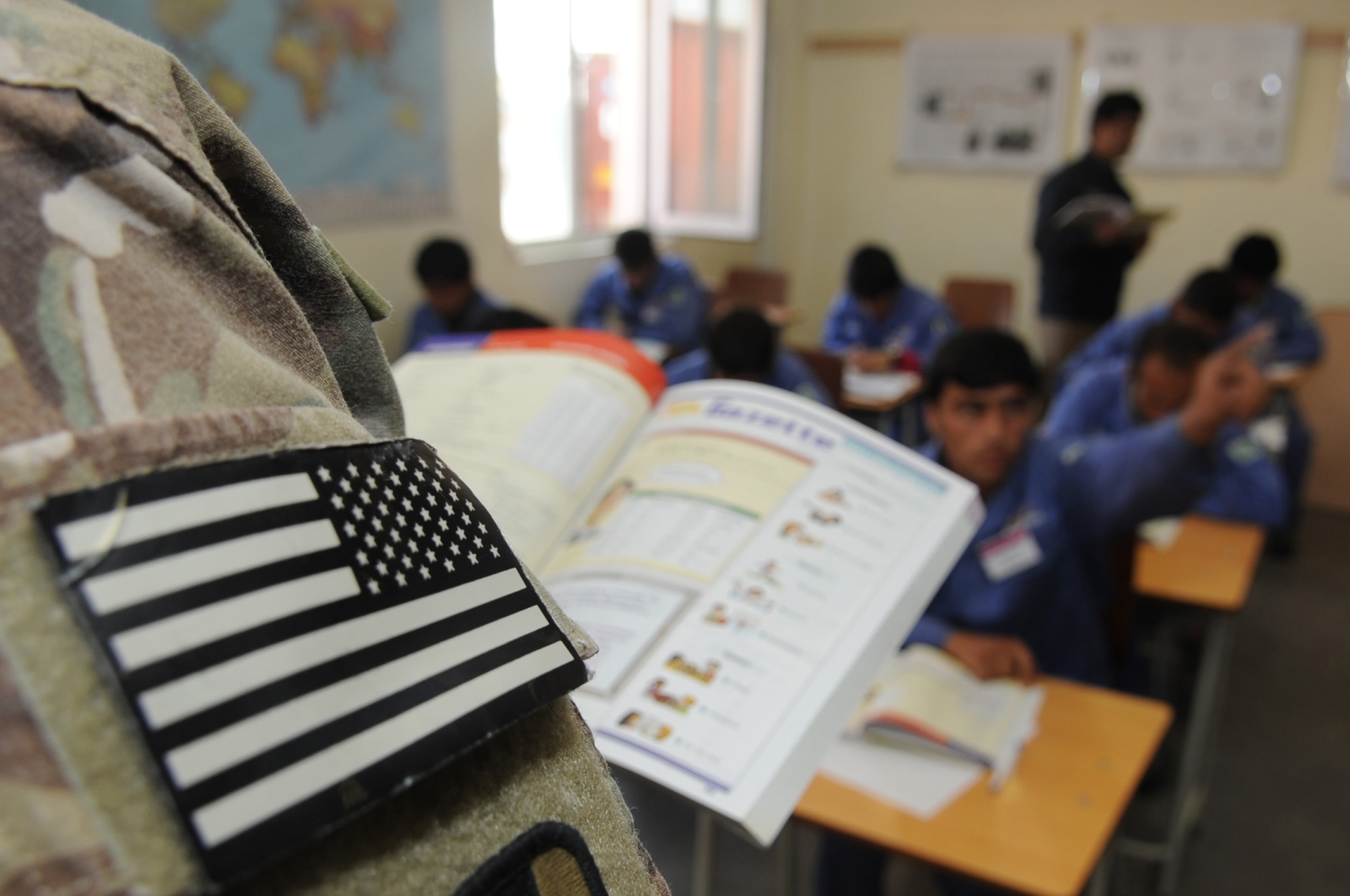 Afghan students participate in an English lesson at the Korean Vocational Training Center on Bagram Airfield, Afghanistan, April 10, 2013. Teams of American Airmen and Soldiers volunteer to lead the classes for the students whose other courses include skills such as carpentry and plumbing. (U.S. Air Force photo/Staff Sgt. David Dobrydney)