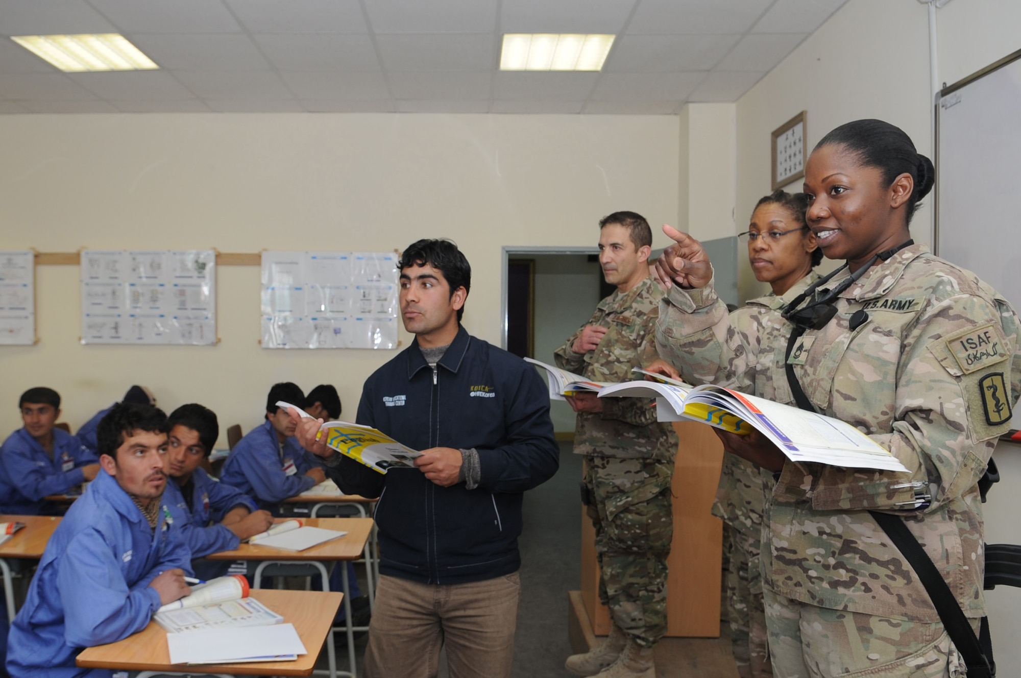 U.S. Army Sgt. 1st Class Kathia McConnico calls on a student during an English lesson at the Korean Vocational Training Center on Bagram Airfield, Afghanistan, April 10, 2013. American Airmen and Soldiers volunteer to teach conversational English to students in addition to their lessons in skills such as carpentry and plumbing here. (U.S. Air Force photo/Staff Sgt. David Dobrydney)