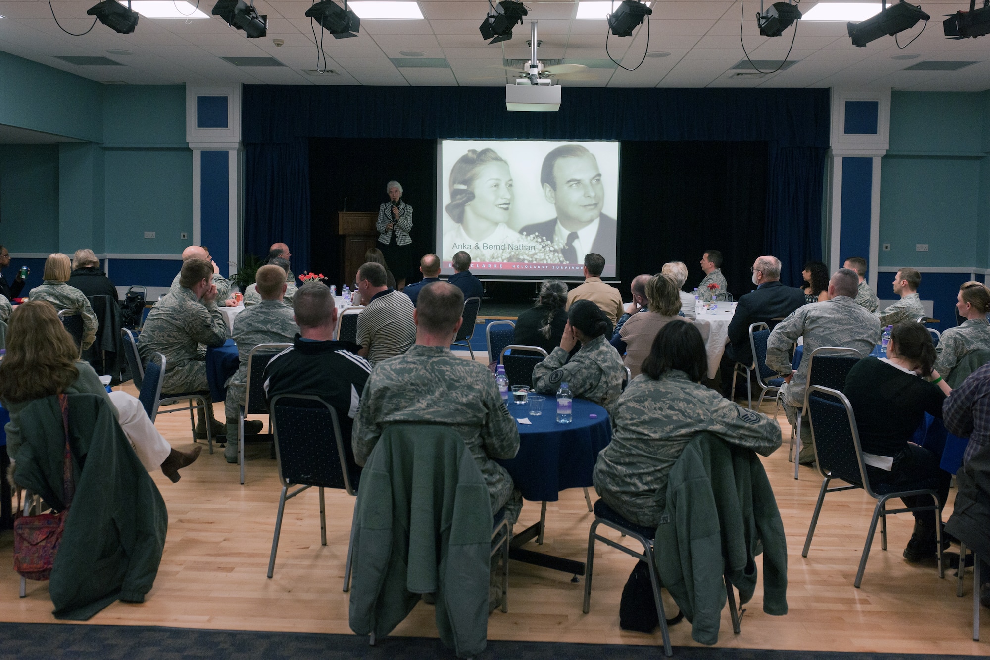 RAF ALCONBURY, United Kingdom – Members of the 501st Combat Support Wing staff agencies and 423rd Air Base Group listen to Eva Clarke, the daughter of a Czech mother and German father, both of whom were Jewish, speak at the Holocaust Remembrance Luncheon at the RAF Alconbury Community Activities Center April 8. She shared her parents’ experiences of being kept prisoner for three years in German concentration camps, saying her parents weren’t her only family members suffering at the hands of the Nazi soldiers. (U.S. Air Force photo by Staff Sgt. Brian Stives)