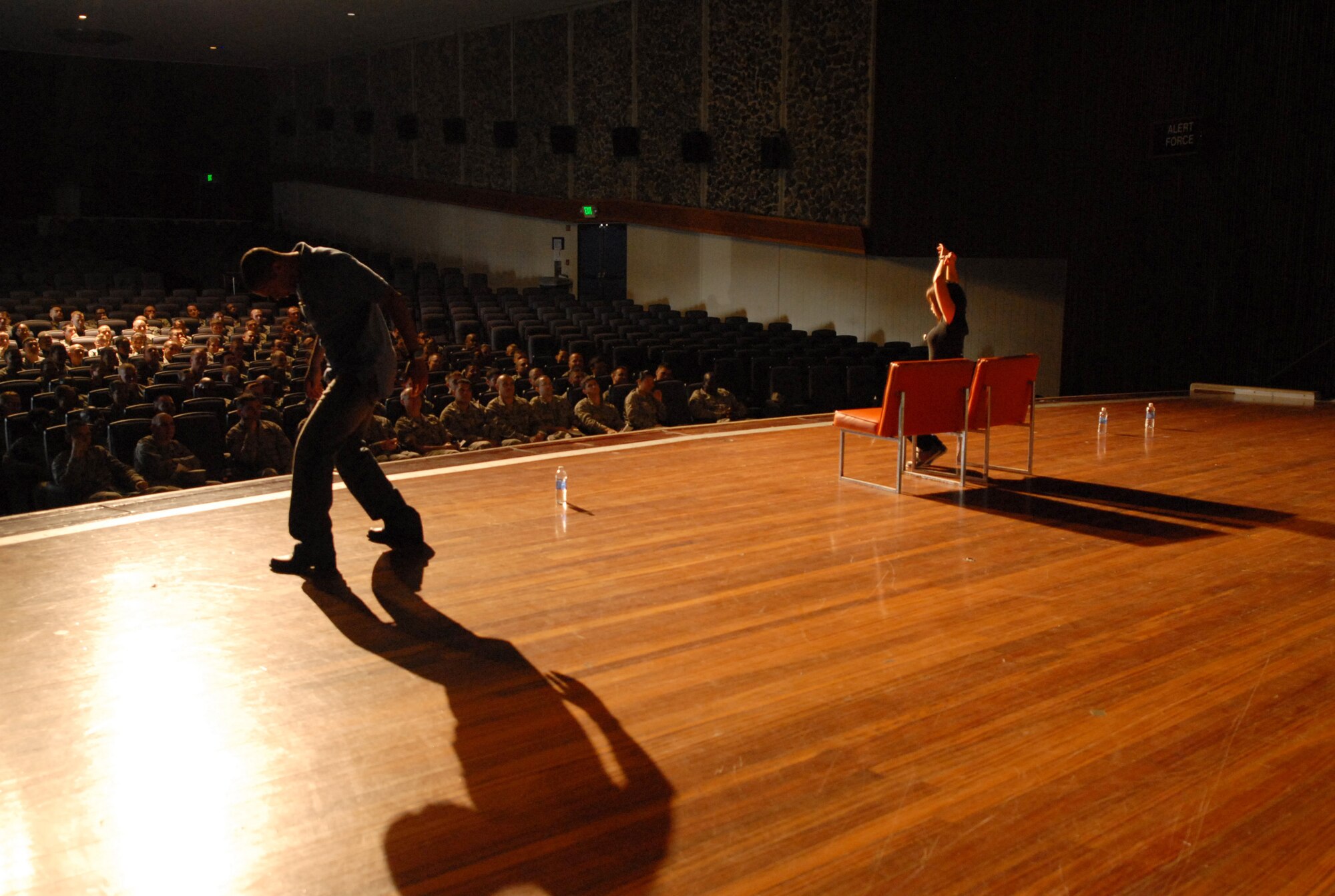 Derante Parker and Kristen Pickering, actor educators of the Catharsis Productions' "Sex Signals" presentation, perform during the presentation at the Keystone Theater on Kadena Air Base, Japan, April 8, 2013. The show highlights dating situations and brings awareness to the reality of sexual assault with wit, humor, and straight talking. The ever-evolving skit currently has a company of 24 actors that travel by pairs around the world to military bases and was hosted on Kadena as part of Sexual Assault Awareness Month. (U.S. Air Force photo by Staff Sgt. Lauren Snyder/Released)