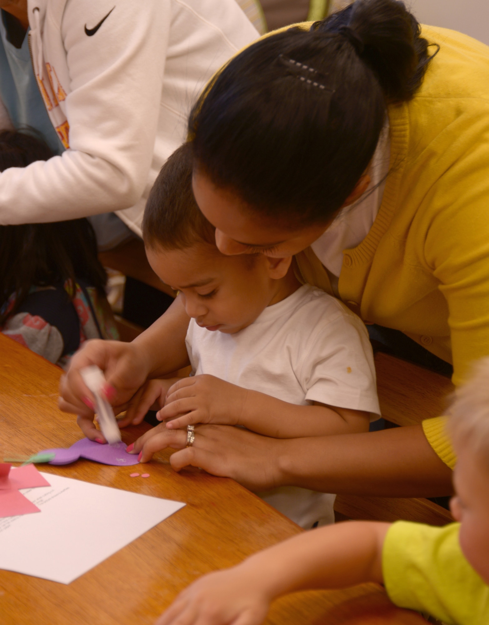 Samantha Garcia and son Alex, 2, family of U.S. Marine Corps Sgt. Thomas Garcia, 3rd Law Enforcement Battalion, make butterflies from construction paper as a craft project for the Days of Remembrance observance, April 10, 2013, Kadena Air Base Japan. The Days of Remembrance are an annual occurrence designed to honor, remember and educate on those who lost their lives during the holocaust. (U.S. Air Force Photo/Tech Sgt. Jocelyn L. Rich-Pendracki)