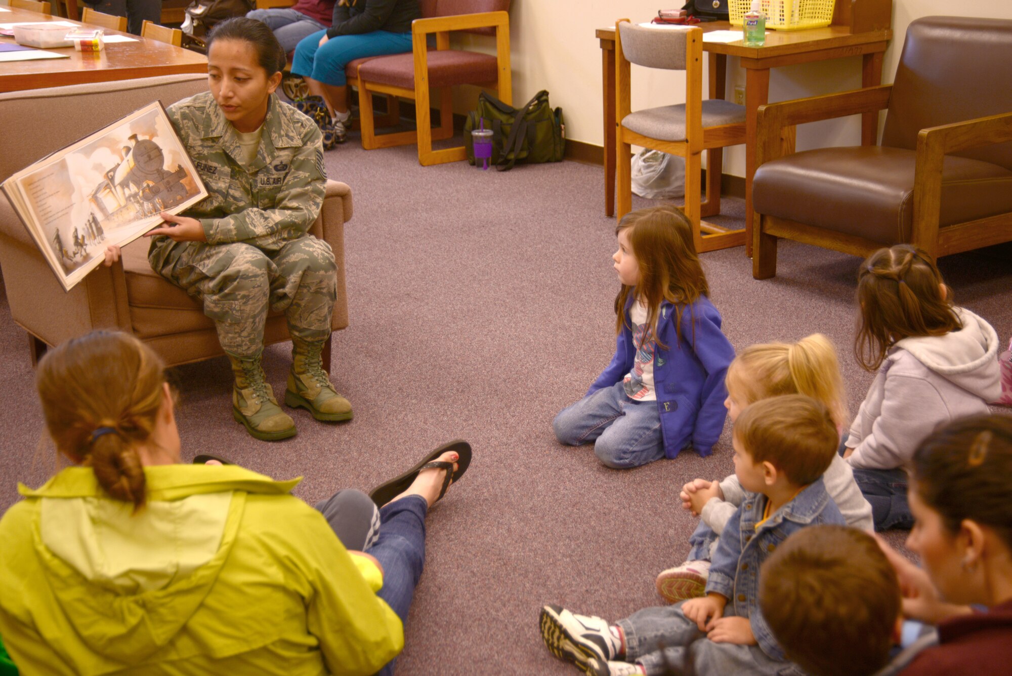 U.S. Air Force Tech Sgt. Jeanine Funez, 82nd Reconnaissance Squadron personnelist, reads a book to children as part of the Days of Remembrance observation, April 10, 2013, Kadena Air Base Japan.  The Days of Remembrance are an annual occurrence designed to honor, remember and educate on those who lost their lives during the holocaust. (U.S. Air Force Photo/Tech Sgt. Jocelyn L. Rich-Pendracki)