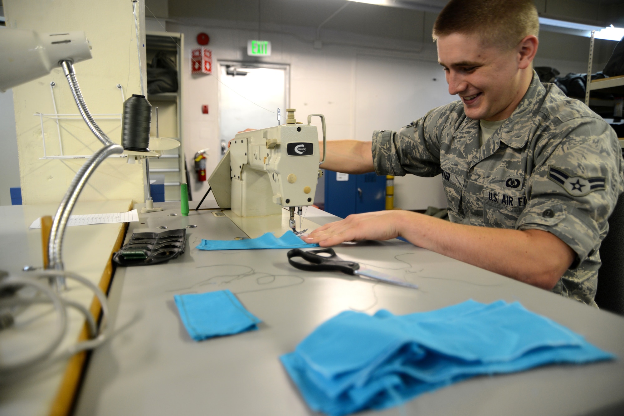 U.S. Air Force Airman 1st Class Nick Meyers, an 18th Operations Support Squadron aircrew flight equipment apprentice, sews fabric into flags to be planted on Douglas Blvd. as a visual reminder of those who have survived sexual assault, March 13, 2013, Kadena Air Base, Japan. April is Sexual Assault Awareness Month and the flags are going to be available by donation at various places around the base. (U.S. Air Force Photo/Tech Sgt. Jocelyn L. Rich-Pendracki)