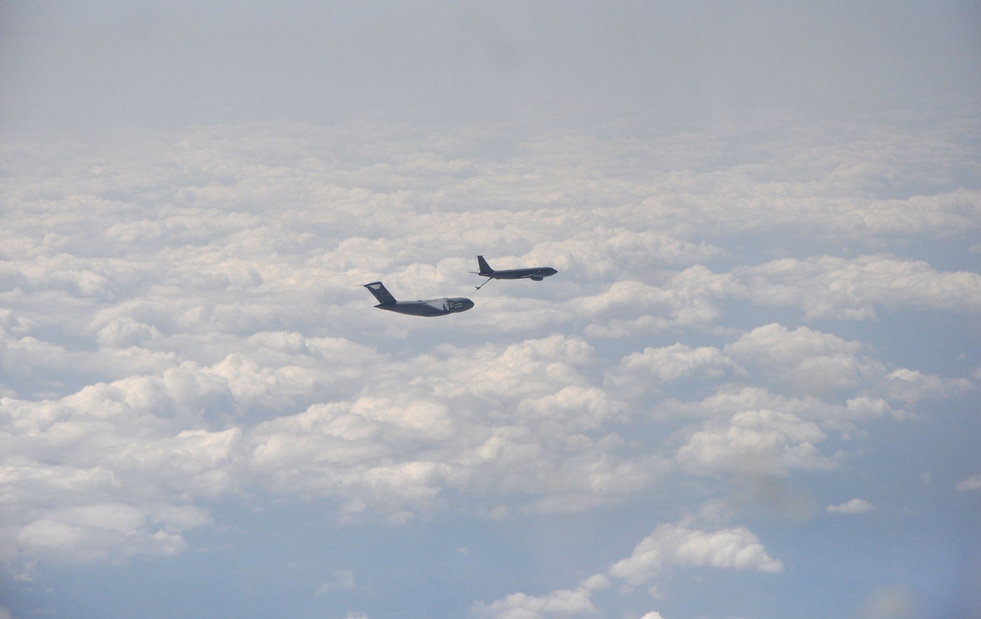 A C-17 Globemaster III performs an aerial refueling manuever with a KC-135 Stratotanker during a recent training mission.  Aircrews from the 437th and 315th Airlift Wings at Joint Base Charleston conducted a large formation exercise (LFE) consisting of 13 C-17 Globemaster III aircraft Wednesday, April 9, 2013.  The mission included a variety of training exercises consisting of airdrops, aerial refueling and low level tactical training. These skills are needed at all times to ensure mission readiness, locally and globally. (U.S. Air Force photo/Senior Airman Bobby Pilch)