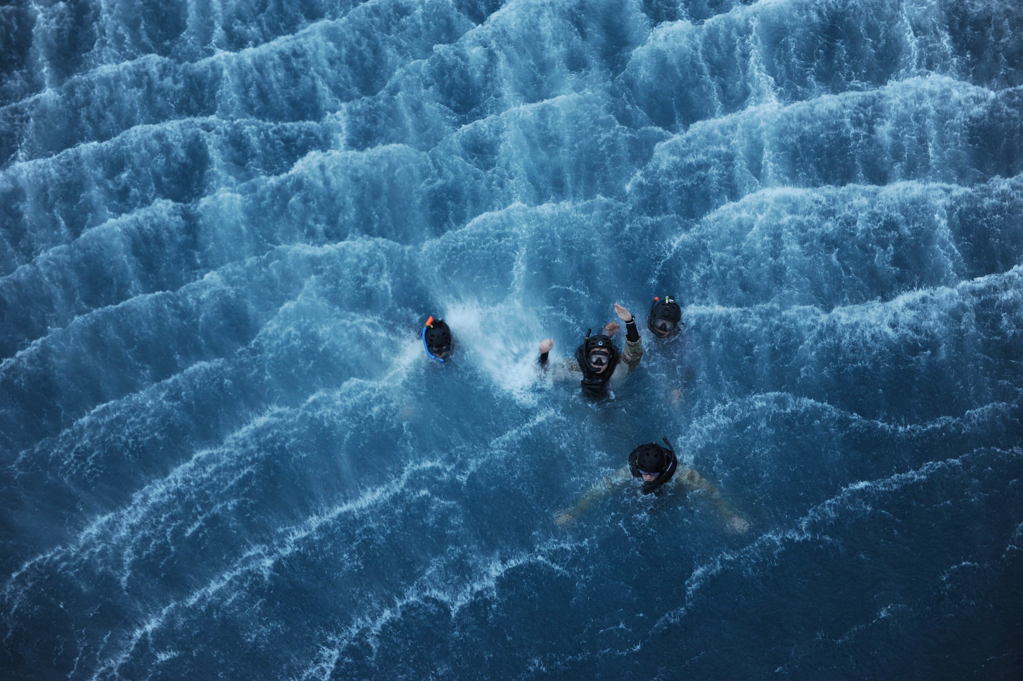 U.S. Air Force Brig. Gen. Matt Molloy, 18th Wing commander, and pararescuemen from the 31st Rescue Squadron tread water during a rescue training scenario on Kadena Air Base, Japan, April 9, 2013. During his flight, Molloy participated in a range training exercise, followed by a day-water rescue scenario. (U.S. Air Force photo by Airman 1st Class Hailey R. Davis) (water rescue)
