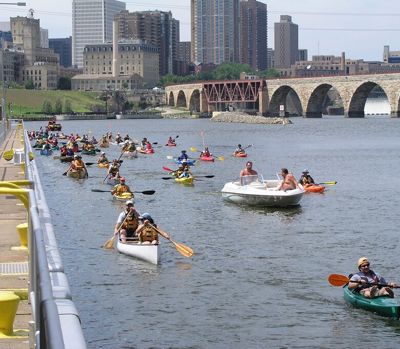 Recreational boaters along the upper guidewall at Lower St. Anthony Falls Lock and Dam wait to enter the lock chamber and continue their trip downstream. (USACE file photo) 
