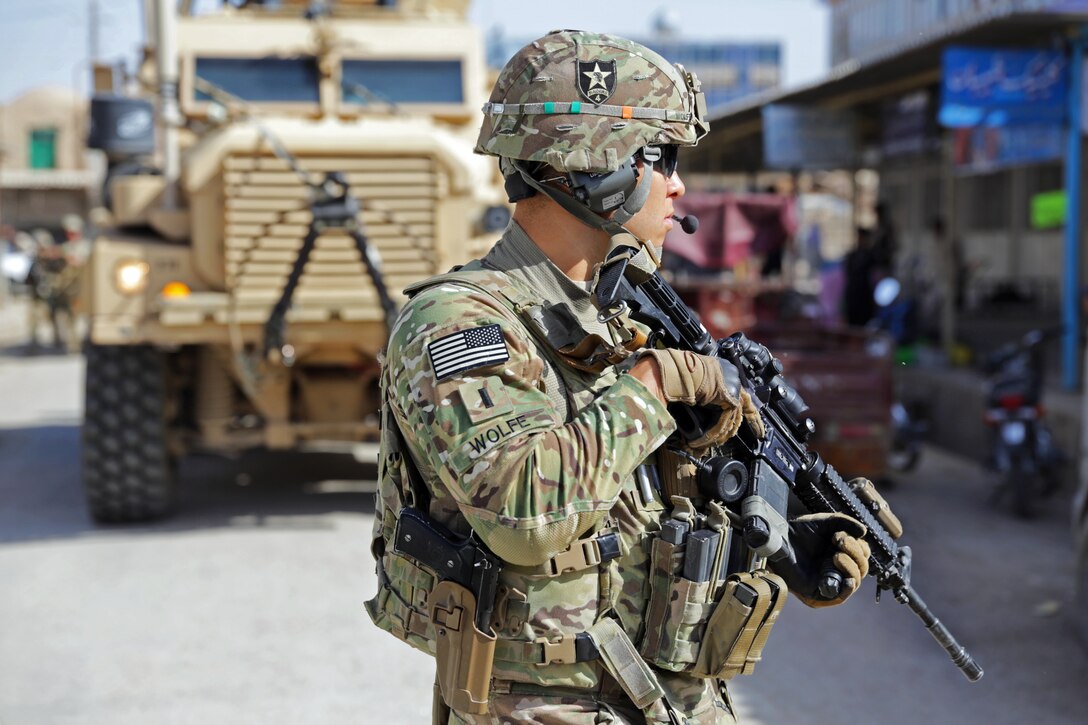 U.S. Army 1st Lt. Robert Wolfe provides security upon arrival at the directorate of information and culture offices for a meeting in Farah city, Afghanistan, April 10, 2013. Wolfe, a platoon leader, is assigned to Provincial Reconstruction Team Farah.