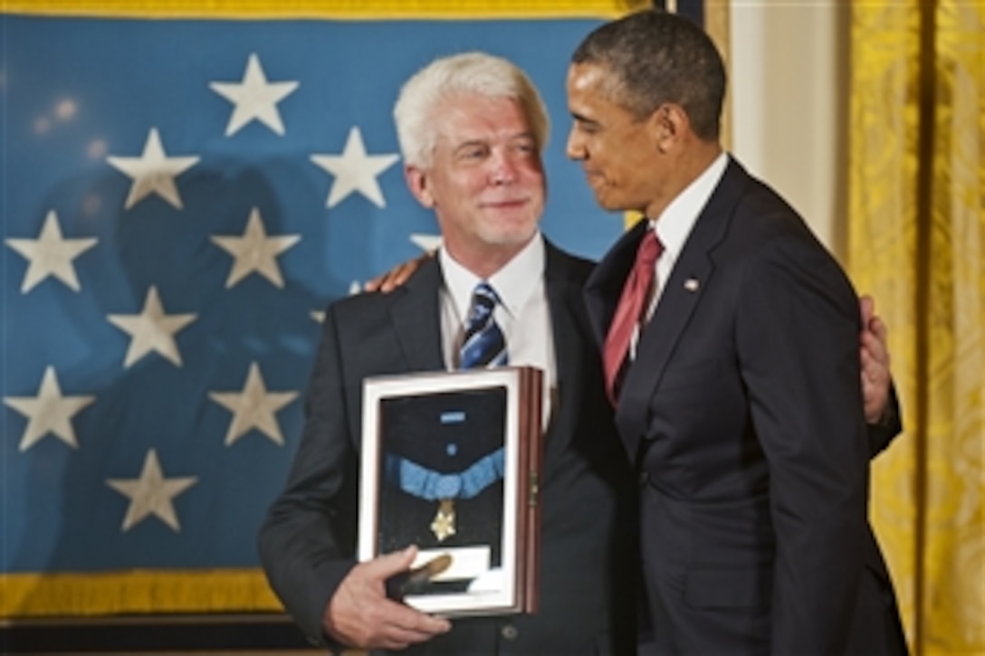 President Barack Obama awards the Medal of Honor to Army Chaplain (Capt.) Emil Kapaun, accepted posthumously by his nephew, Ray, during a ceremony in the East Room of the White House, April 11, 2013.