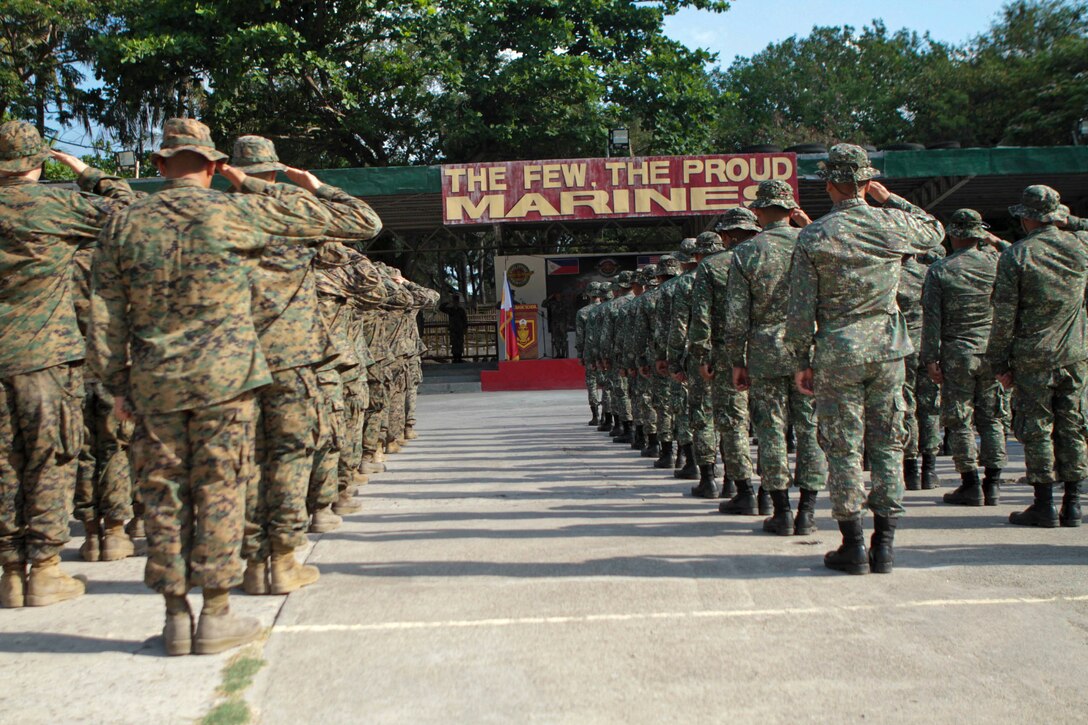 Marines and Sailors with Company B., Battalion Landing Team 1st Battalion, 5th Marines, 31st Marine Expeditionary Unit, and Marines from the Philippine Marine Corps salute the flag while the U.S. and Philippine national anthems play during the opening ceremony of exercise Balikatan 2013 here, April 7. Now in its 29th iteration, this exercise gives U.S Marines the opportunity to train alongside their Philippine counterparts and become more familiar with the Pacific jungle environment. The 31st MEU is the only continuously forward-deployed MEU and is the Marine Corps’ force in readiness in the Asia-Pacific region.