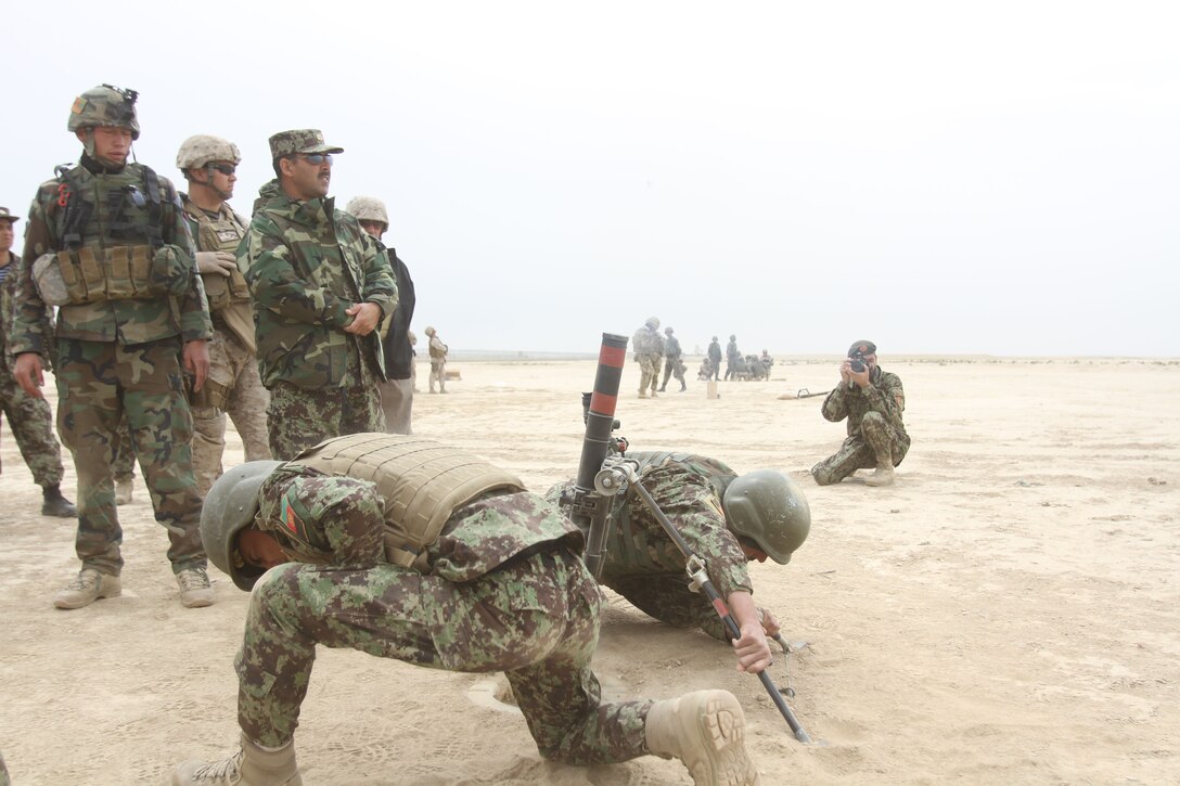 Afghan National Army infantry soldiers, who recently graduated ANA basic training, conduct M224 60mm mortar training operations at the Regional Military Training Center aboard Camp Shurabak, Washir District, Helmand Province, Afghanistan. Afghan National Army Maj. Gen. Sayeed Malook, the 215th Corps commanding general, and Maj. Gen. W. Lee Miller, the Regional Command (Southwest) commanding general were on hand to witness the training. The 215th Corps Security Force Assistance Advisor Team Marines guide, assist and advise the 215th Corps, but Afghan soldiers conducted the training, while the SFAAT Marines ensured the ANA soldiers were meeting safety requirements.