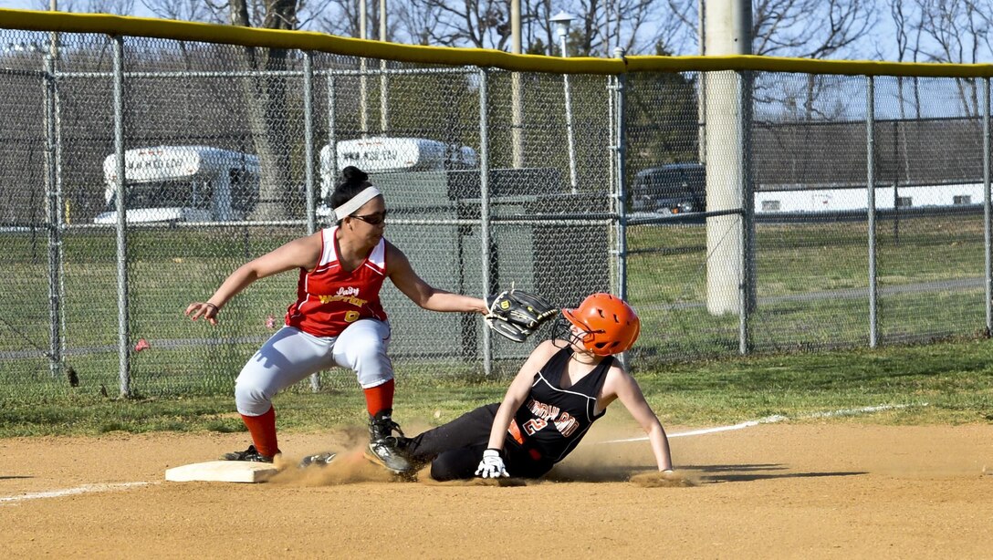 Emily, Maryland School for the Deaf Oriole’s pitcher, slides to third base in attempt to beat out Quantico Lady Warrior’s third baseman during a softball game at Quantico, April 9, 2013. Emily stole second, third and home to advance her team to victory over the Lady Warriors, 12-10.