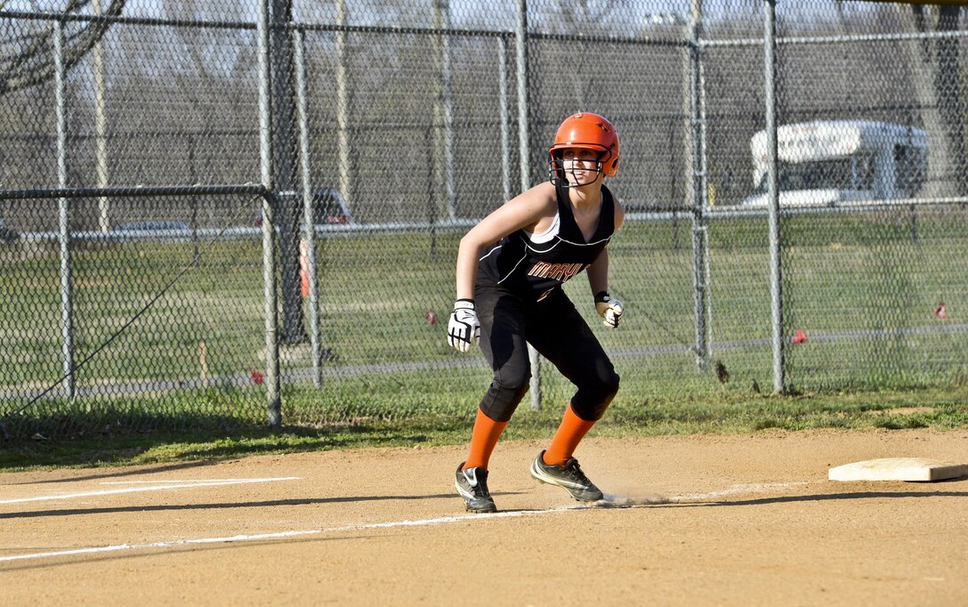 Emily, Maryland School for the Deaf Oriole’s pitcher, keeps her eye on the pitcher as she prepares to steal home base during a softball game against the Quantico Lady Warrior’s at Quantico on April 9, 2013. Emily went on to score on her attempt.