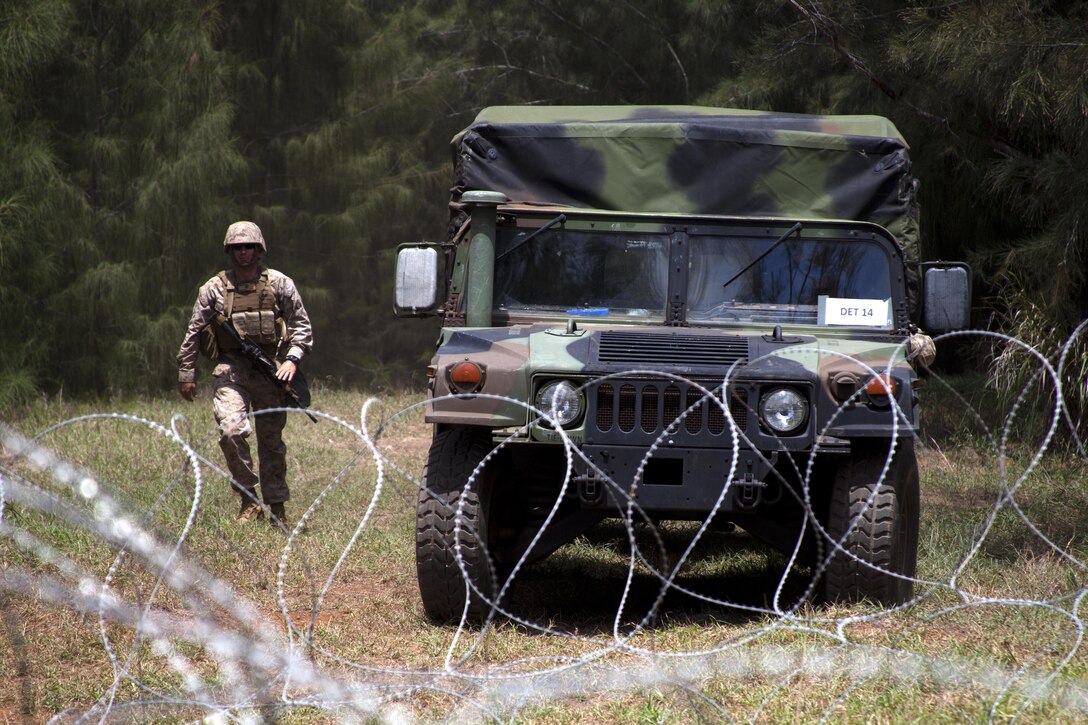 KAHUKU TRAINING AREA, Hawaii — A Marine with 3rd Radio Battalion guides a humvee during a 10-day mission rehearsal exercise at Kahuku Training Area, April 8.(Official U.S. Marine Corps photo by Lance Cpl. Nathan Knapke) 