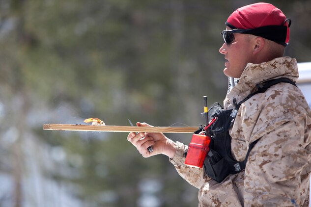 MOUNTAIN WARFARE TRAINING CENTER, BRIDGEPORT, Calif. - Staff Sgt. Scott Coffin, a Mountain Warfare Training Center instructor, shows Marines of Golf Company, 2nd Battalion, 3rd Marine Regiment, the cotton ball and petroleum jelly method for starting a fire during a basics for survival training course at MWTC in Bridgeport, Calif., April 5, 2013. (U.S. Marine Corps photo by Lance Cpl. Suzanna Lapi)
