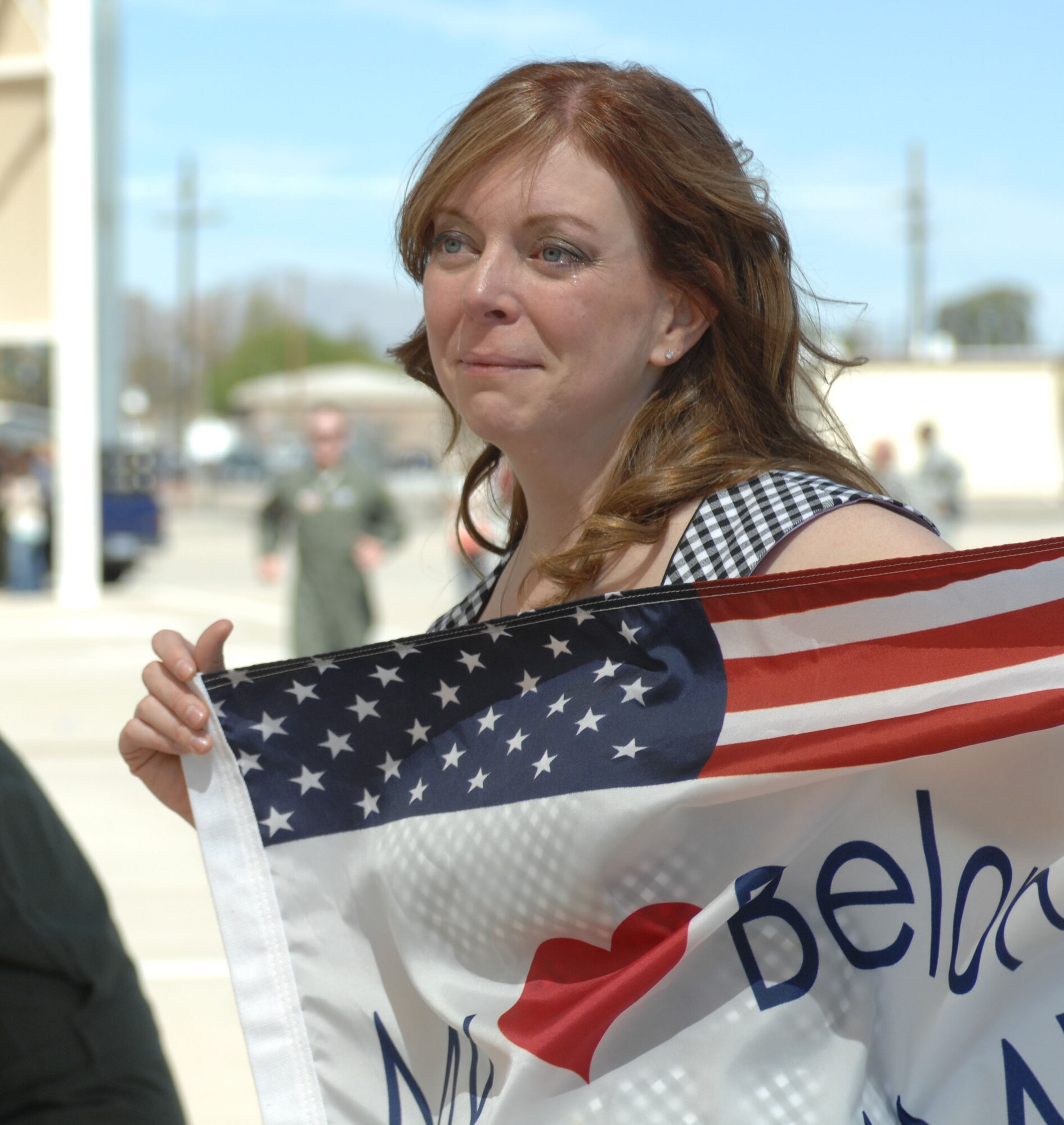 Betsy Walls cries while waiting for her husband, Lt. Col. Daniel Walls, 354th Fighter Squadron pilot, to disembark from his aircraft at Davis-Monthan Air Force Base, April 11, 2013. Lt. Col. Walls returned home from a six-month deployment in Bagram Airbase, Afghanistan. (U.S. Air Force photo by Airman 1st Class Betty R. Chevalier/released)