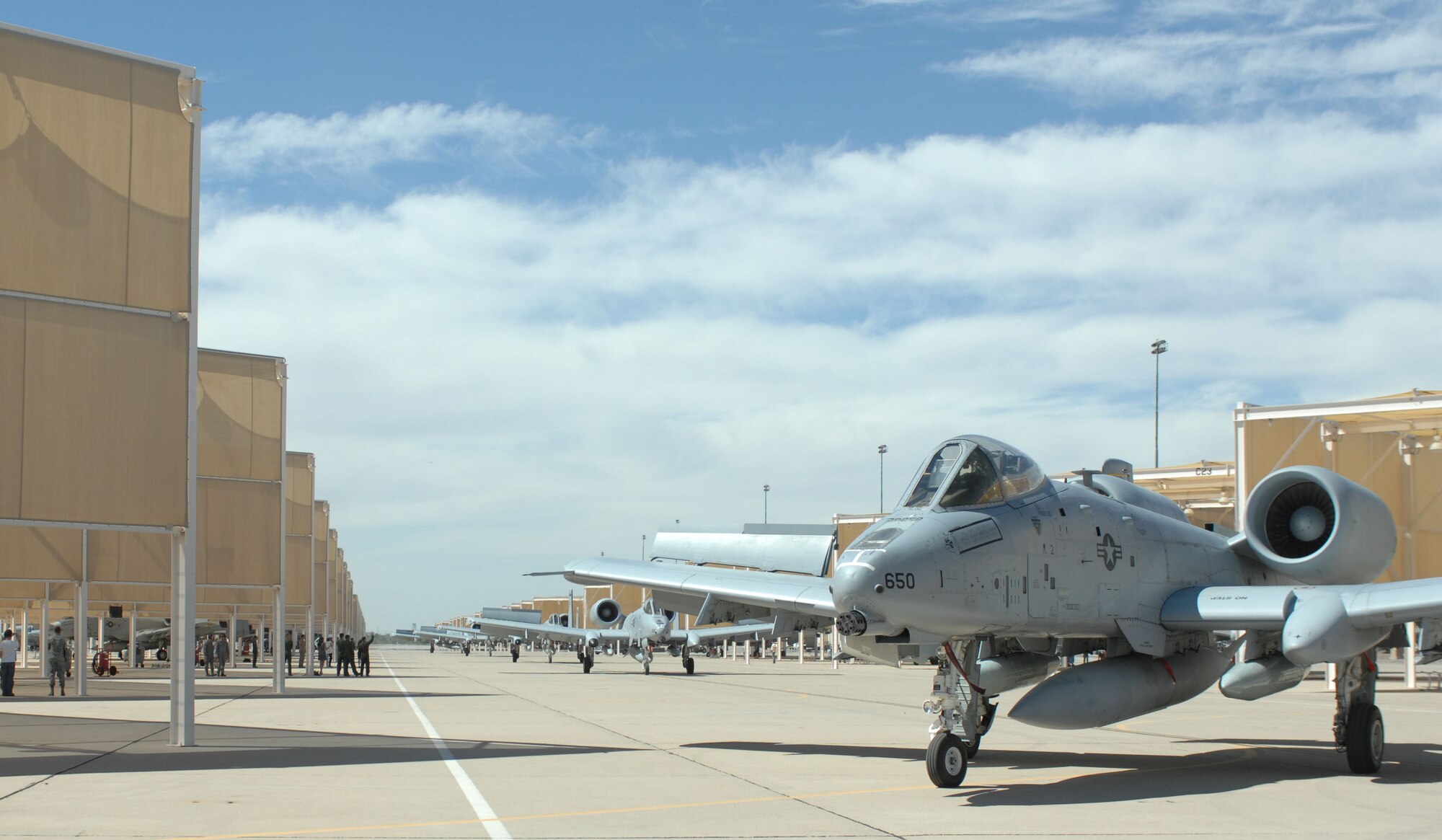 A-10C Thunderbolt II aircraft taxi into hangers at Davis-Monthan Air Force Base, April 11, 2013 after returning from a deployment. The A-10s flew more than 10,000 combat hours in Afghanistan since being deployed in September 2012. (U.S. Air Force photo by Airman 1st Class Betty R. Chevalier/released)
