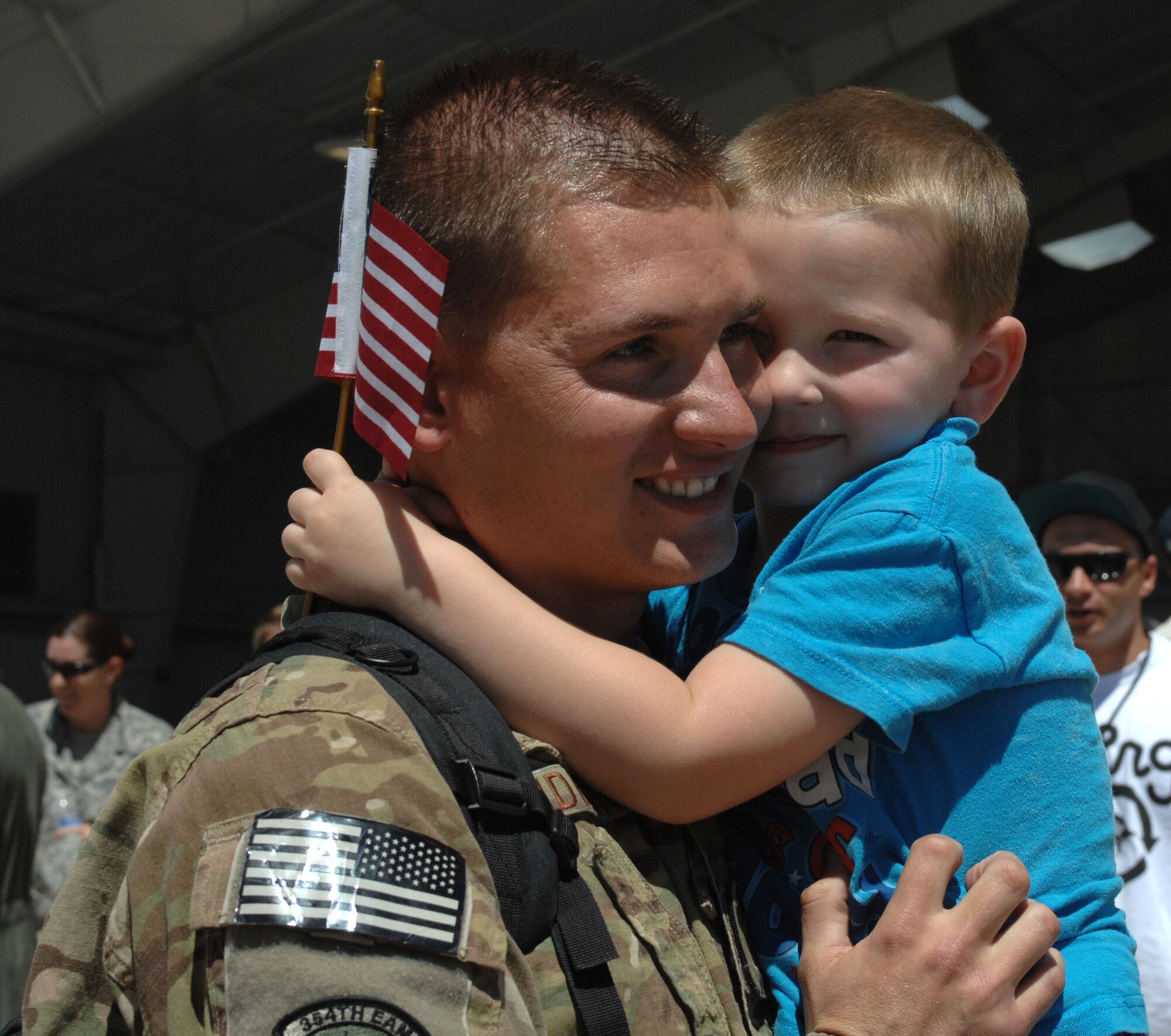 U.S. Air Force Staff Sgt. Jacob Candland, 355th Maintenance Group aircrew egress systems craftsman, returns from a deployment to be greeted by his son at Davis-Monthan Air Force Base, April 11, 2013. Candland was deployed to Afghanistan in September 2012 with the 355th MXG in support of Operation Enduring Freedom. (U.S. Air Force photo by Airman 1st Class Betty R. Chevalier/released)