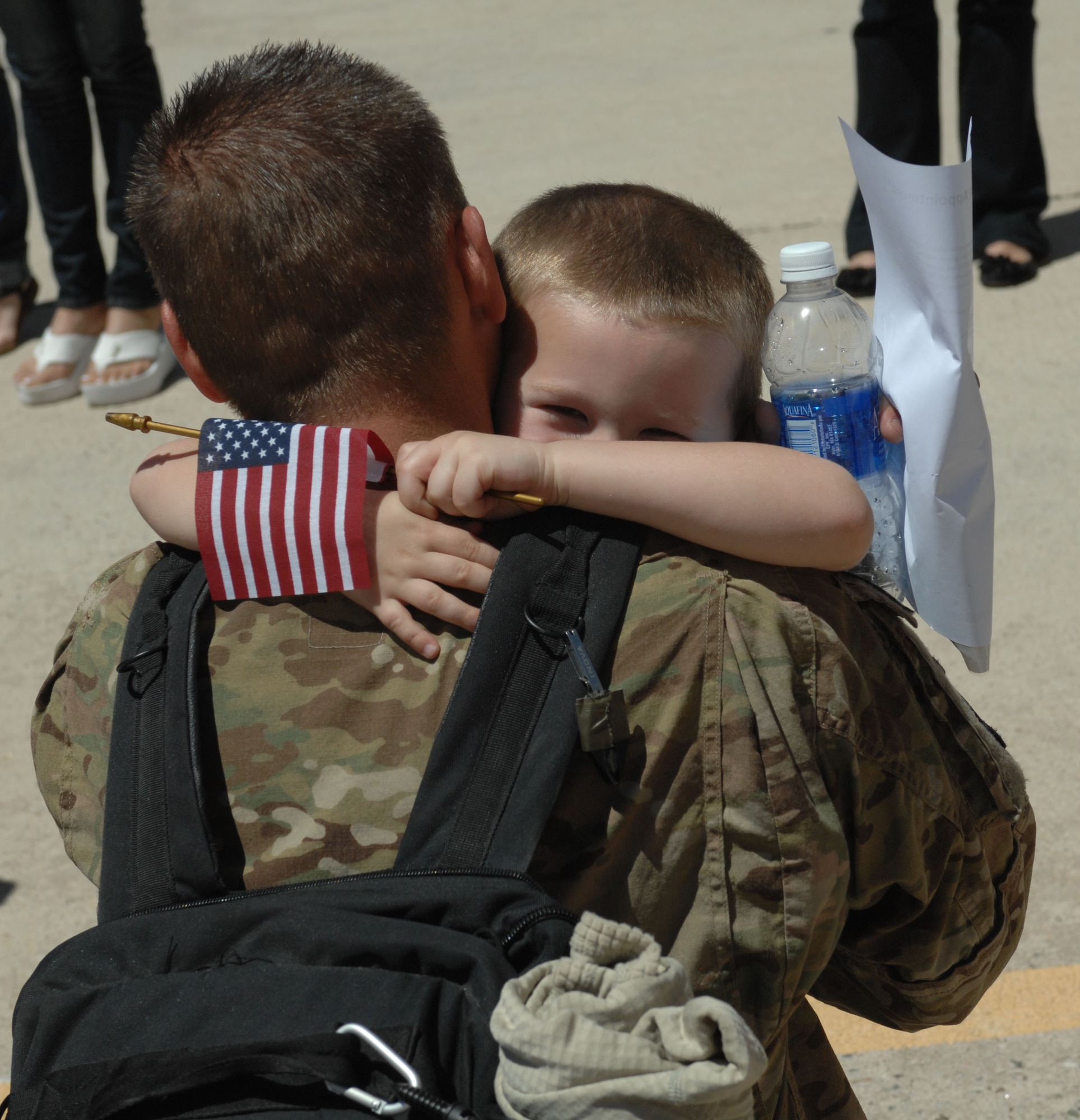 U.S. Air Force Staff Sgt. Jacob Candland, 355th Maintenance Group aircrew egress systems craftsman, hugs his son for the first time in six months at Davis-Monthan Air Force Base, April 11, 2013. Candland has been deployed with the 355th MXG since September 2012 to Bagram Airfield, Afghanistan.(U.S. Air Force photo by Airman 1st Class Betty R. Chevalier/released)