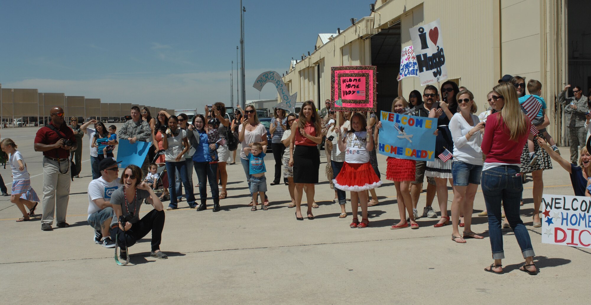 Family and friends wait to greet A-10 pilots and aircrew from the 354th Fighter Squadron and 355th Maintenance Group at Davis-Monthan Air Force Base, April 11, 2013. The Airman have been deployed since September 2012 to Bagram Airfield, Afghanistan. (U.S. Air Force photo by Airman 1st Class Betty R. Chevalier/released)