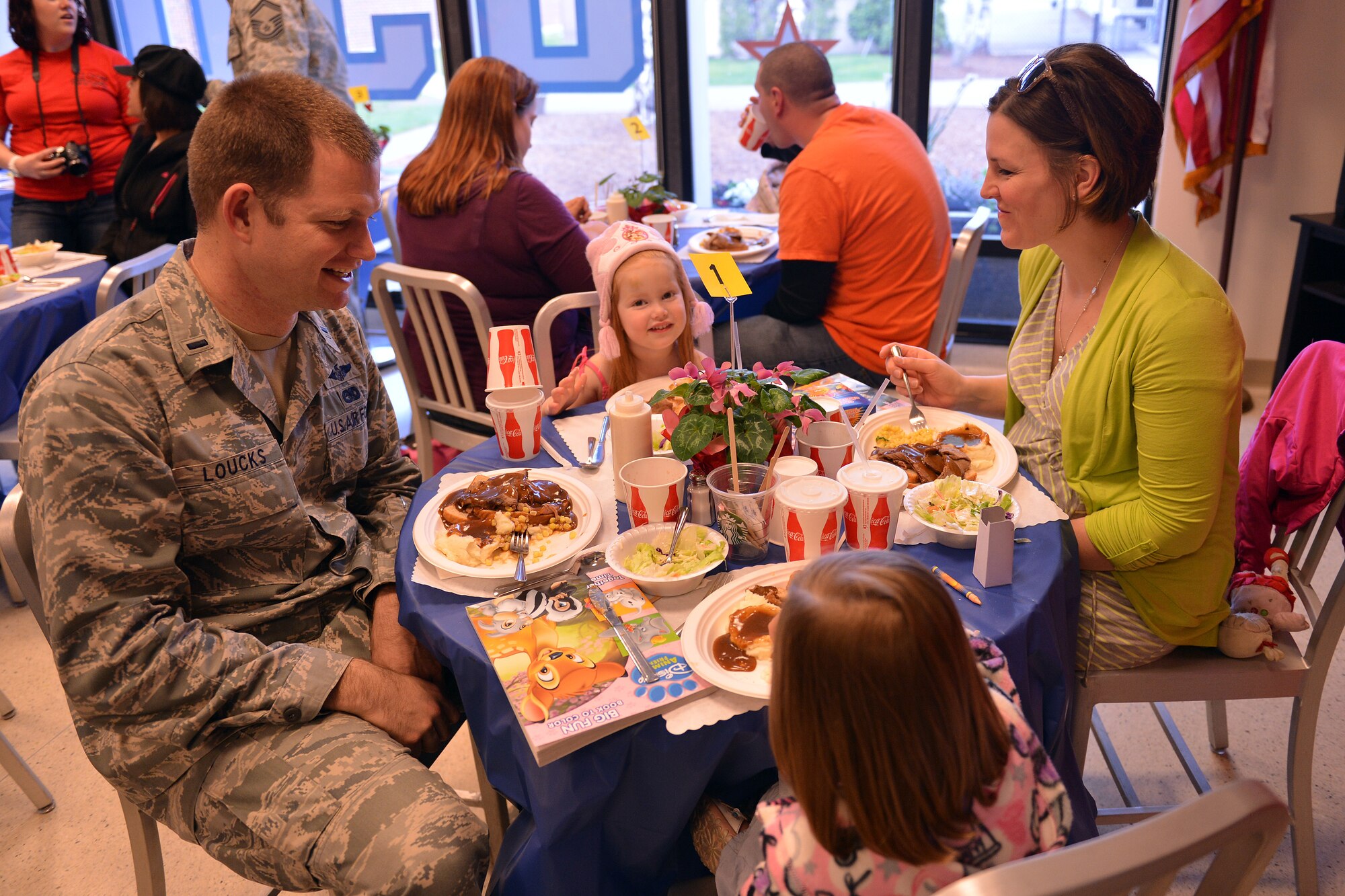 1st Lt. Jason Loucks, 62nd Aerial Port Squadron air freight flight commander, enjoys dinner with his wife Candace and his two daughters, Havan and Aubrey, during the USO's “No Dough Dinner” night, April 11, 2013, at Joint Base Lewis-McChord, Wash. The USO's new program offers Airmen and their families a free dinner one night toward the end of each pay period. (U.S. Air Force photo/Airman 1st Class Jacob Jimenez)