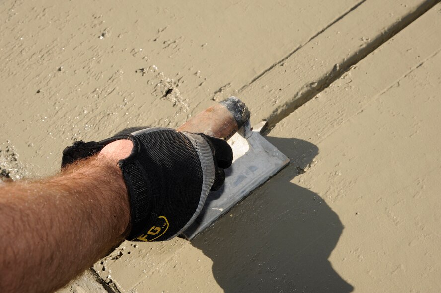 Staff Sgt. Jody Branson, 2nd Civil Engineer Squadron Heavy Repair section, smooths edges out of a freshly laid sidewalk on Barksdale Air Force Base, La., April 12, 2013. Heavy Repair Airmen from 2 CES, known as the "Dirt Boys", are responsible for maintaining Barksdale's infrastructure and spearheading construction projects. (U.S. Air Force photo/Airman 1st Class Andrew Moua)