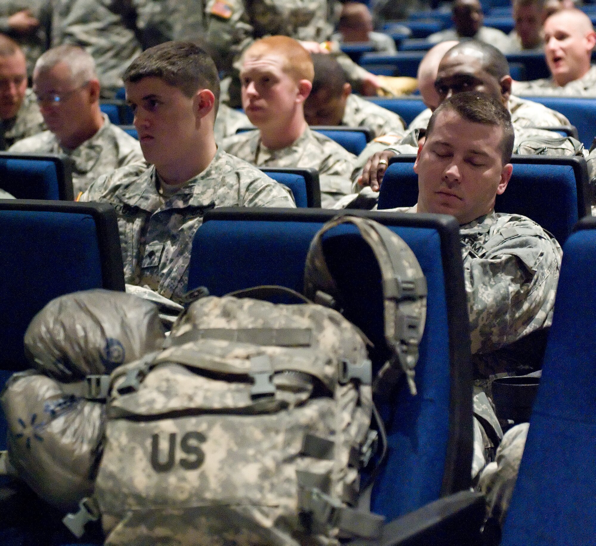 Staff Sgt. Kevin Baron, a member of Company A, 198th Expeditionary Signal Battalion, Delaware National Guard, Georgetown, Del., takes a short nap before a mass pre-mobilization briefing April 12, 2013, at Dover Air Force Base, Del. More than 300 soldiers of the 198th ESB are being deployed to Afghanistan for one year. (U.S. Air Force photo/Roland Balik)
