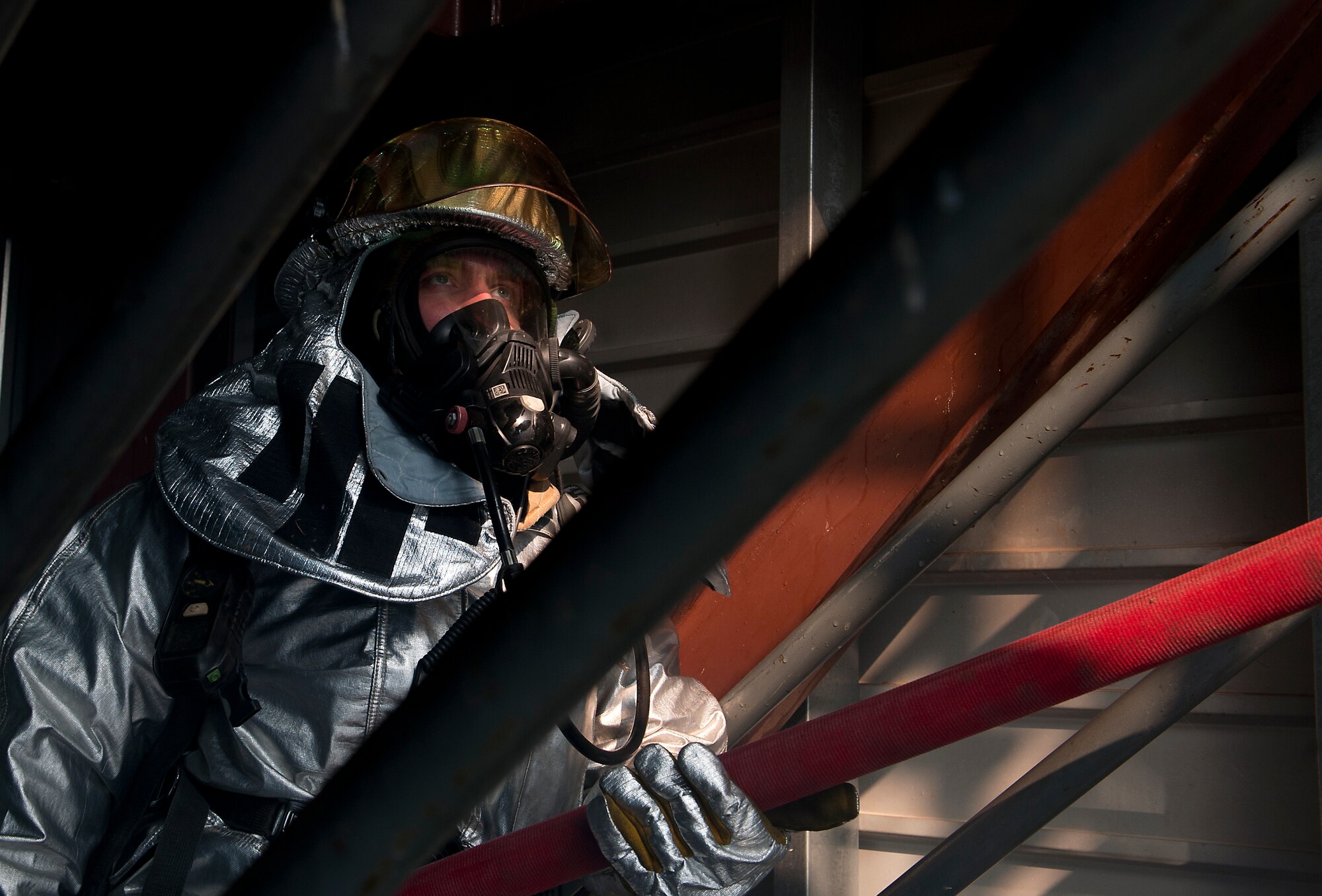 Staff Sgt. Clayton Webb, 7th Civil Engineer Squadron, feeds a fire hose up the staircase of a smoke house during an Operational Readiness Exercise April 11, 2013, at Dyess Air Force Base, Texas. An ORE is one of many exercises designed to test a base’s ability to deploy quickly. The first two days of the exercise were conducted as a Phase I exercise and the last two as a Phase II exercise. In Phase II, Airmen traveled to Ray Rangel Air Base, Dyess’ mock deployment location, where Airmen were tested on their ability to function in a deployed environment. While at Ray Rangel, Airmen faced many challenges in the form of injects, which are scenarios that can vary from unexploded ordinances to opposition forces attacking the base. (U.S. Air Force photo by Airman 1st Class Damon Kasberg/ Released)