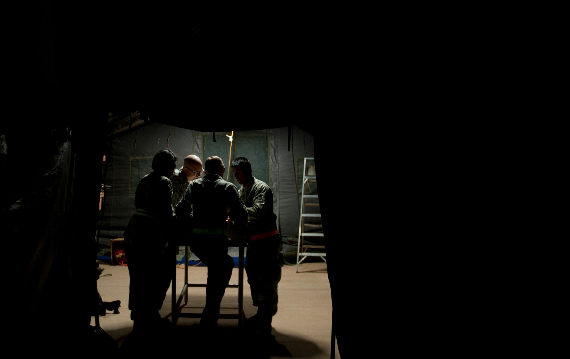 Members of the 7th Force Support Squadron discuss their game plan for their 12-hour shift during an Operational Readiness Exercise April 9, 2013, at Dyess Air Force Base, Texas. An ORE is one of many exercises designed to test a base’s ability to deploy quickly. The first two days of the exercise were conducted as a Phase I exercise and the last two as a Phase II exercise. In Phase II, Airmen traveled to Ray Rangel Air Base, Dyess’ mock deployment location, where Airmen were tested on their ability to function in a deployed environment. While at Ray Rangel, Airmen faced many challenges in the form of injects, which are scenarios that can vary from unexploded ordinances to opposition forces attacking the base. (U.S. Air Force photo by Airman 1st Class Damon Kasberg/ Released)
