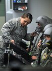 U.S. Air Force Tech. Sgt. Jennifer Flecker, an aerospace and operational physiologist technician from Dyess Air Force Base, Texas, secures oxygen masks to Airmen inside a high-altitude pressure chamber April 4 at Offutt Air Force Base, Neb. This simulated flight marked the end of the chamber’s 56 year history at Offutt. (U.S. Air Force Photo by Josh Plueger/Released)