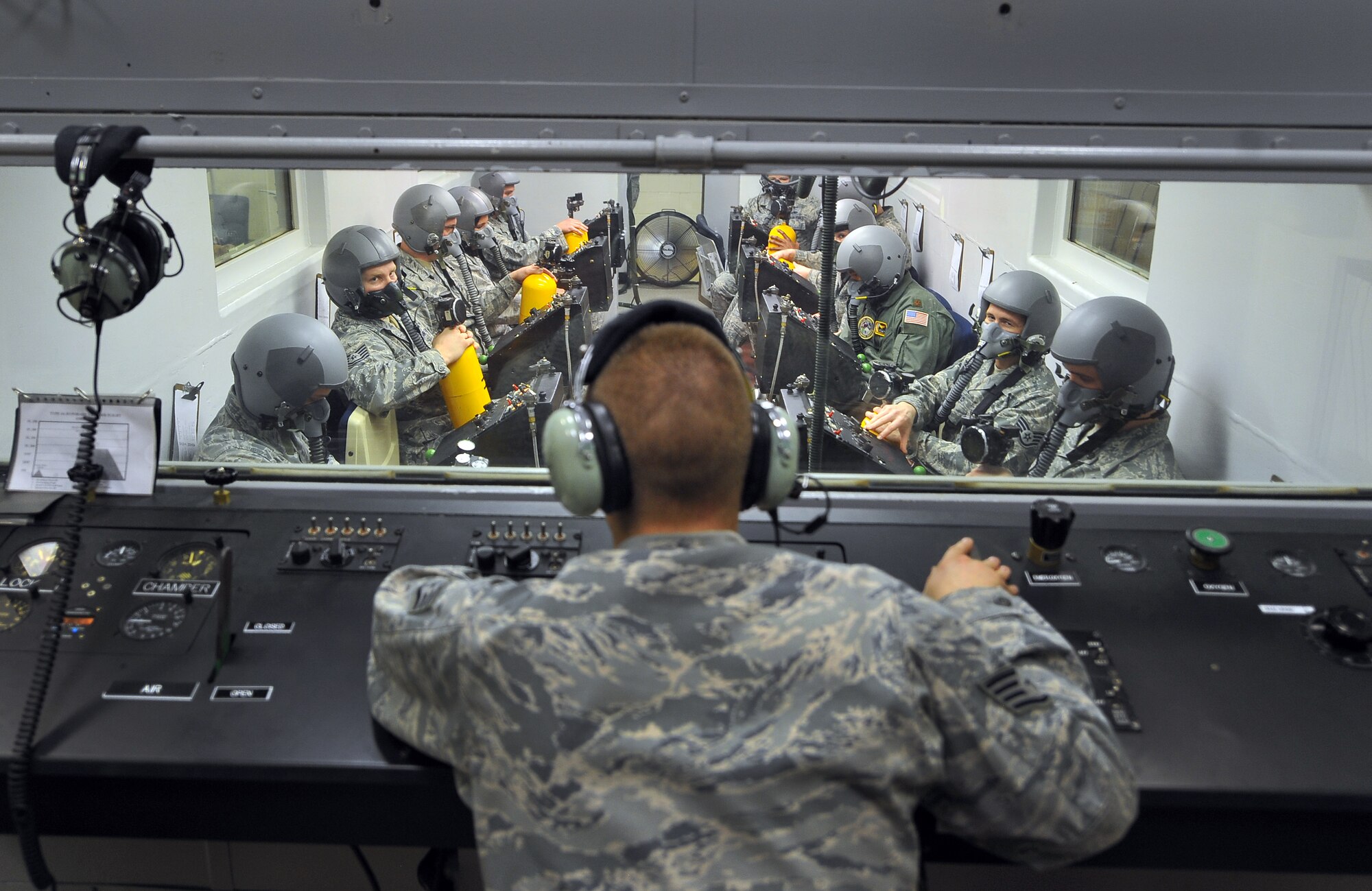 U.S. Air Force Staff Sgt. John Patrick Thorpe, aerospace and operational physiologist technician from Beale Air Force Base, Calif., provides instructions to Airmen prior to their high altitude training test inside a high-altitude chamber April 4 at Offutt Air Force Base, Neb. This group of Airmen was part of the chamber’s “fini-flight,” which marked the end of more than 50 years the chamber has simulated high altitude conditions for flyers across the U.S. and foreign military. It was built in 1957 out of World War II battleship steel. (U.S. Air Force Photo by Josh Plueger/Released)