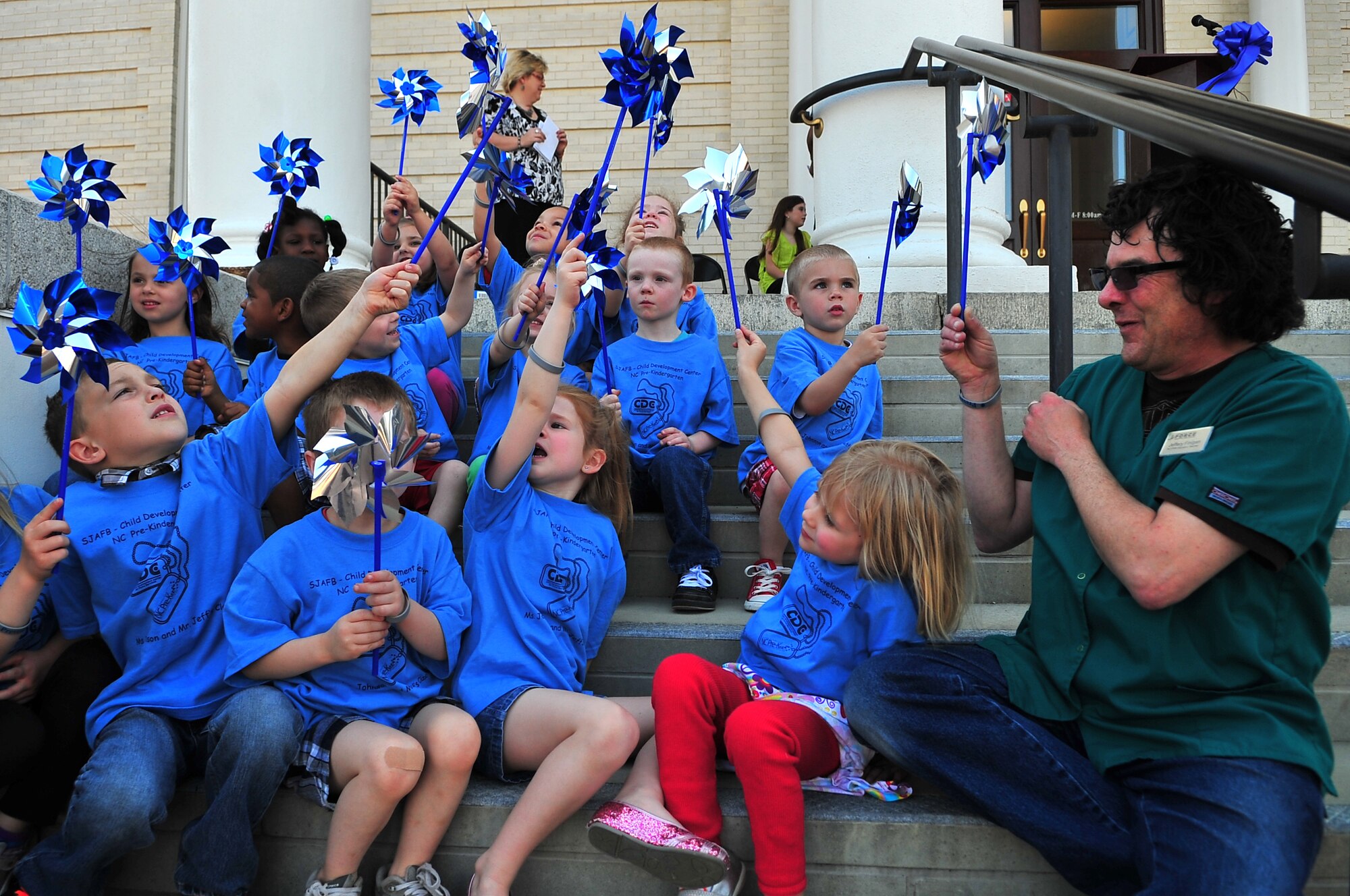 A Child Development Center class plays with pinwheels during the Child Abuse Prevention Proclamation Ceremony on the steps of City Hall in Goldsboro, N.C., April 10, 2013. The children were given pinwheels which are used as a symbol to represent the effort to support families and reduce child abuse. (U.S. Air Force photo by Airman 1st Class Aubrey White/Released)