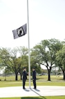 U.S. Air Force Maj. Mark Fogel and Capt. John Scott, both from the 560th Flying Training Squadron, raise the Prisoner of War flag at Heritage Park April 12 during the flag raising and wreath laying ceremony at Joint Base San Antonio-Randolph. The reunion is a celebration of repatriated Vietnam prisoners of war. The 560th Flying Training Squadron gave American pilots, who returned in 1973 from imprisonment in North Vietnam, their “freedom flight” to honor their return.  (U.S. Air Force photo by Melissa Peterson)