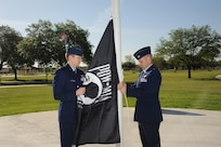 U.S. Air Force Maj. Mark Fogel and Capt. John Scott, both from the 560th Flying Training Squadron, raise the Prisoner of War flag at Heritage Park April 12 during the flag raising and wreath laying ceremony at Joint Base San Antonio-Randolph. The reunion is a celebration of repatriated Vietnam prisoners of war. The 560th Flying Training Squadron gave American pilots, who returned in 1973 from imprisonment in North Vietnam, their “freedom flight” to honor their return.  (U.S. Air Force photo by Melissa Peterson)