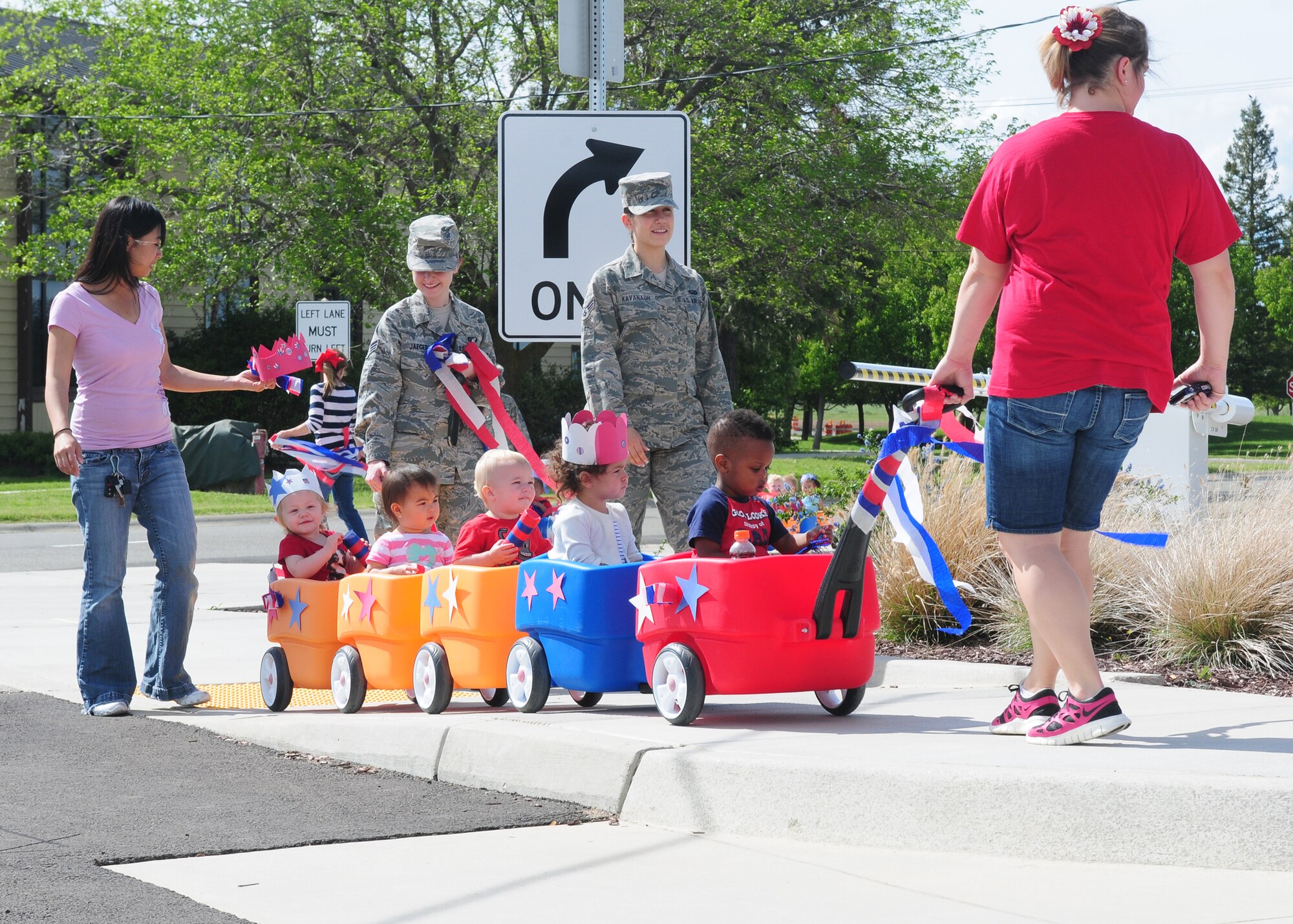 Staff and children of the Child Development Center participate in a parade celebrating the month of the military child at Beale Air Force Base Calif., April 5, 2013. Parents joined and supported their children as the paraded around the CDC in celebration. (U.S. Air Force photo by Senior Airman Allen Pollard/Released)
