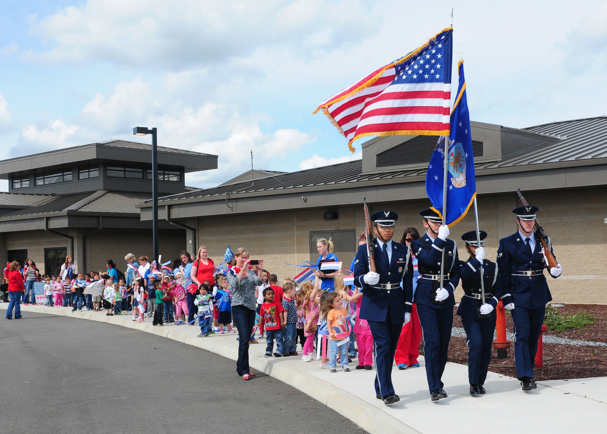 Team Beale's Honor Guard leads a parade hosted by the Child Development Center at Beale Air Force Base Calif., April 5, 2013. The CDC hosted a parade for the children in celebration of the month of the military child. (U.S. Air Force photo by Senior Airman Allen Pollard/Released)