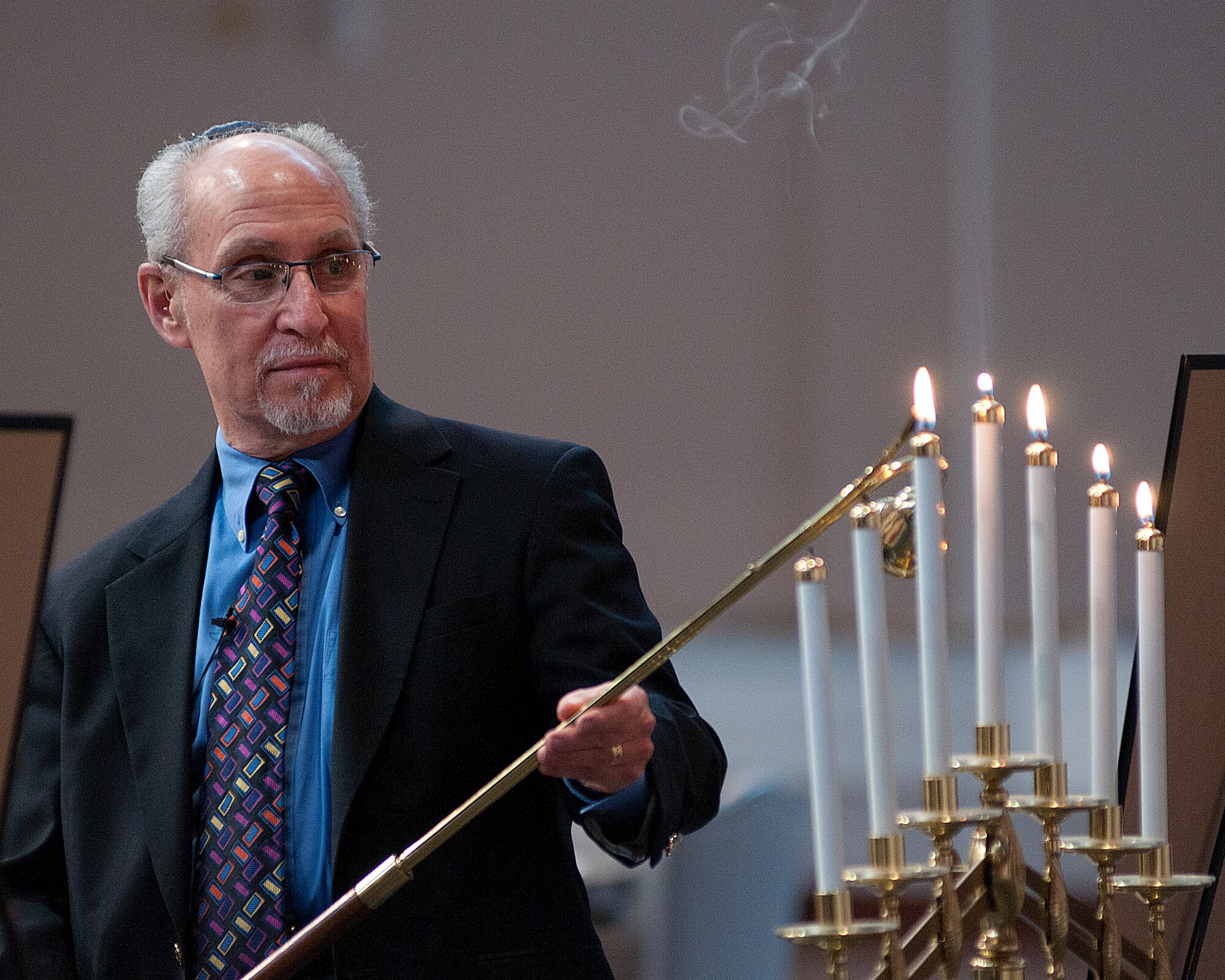 Rabbi Harley Karz-Wagman, of the Mount Sinai Synagogue in Cheyenne, lights candles during during the F. E. Warren Air Force Base Holocaust remembrance event in the Fall Hall Community Center April 8. (U.S. Air Force photo by R.J. Oriez)