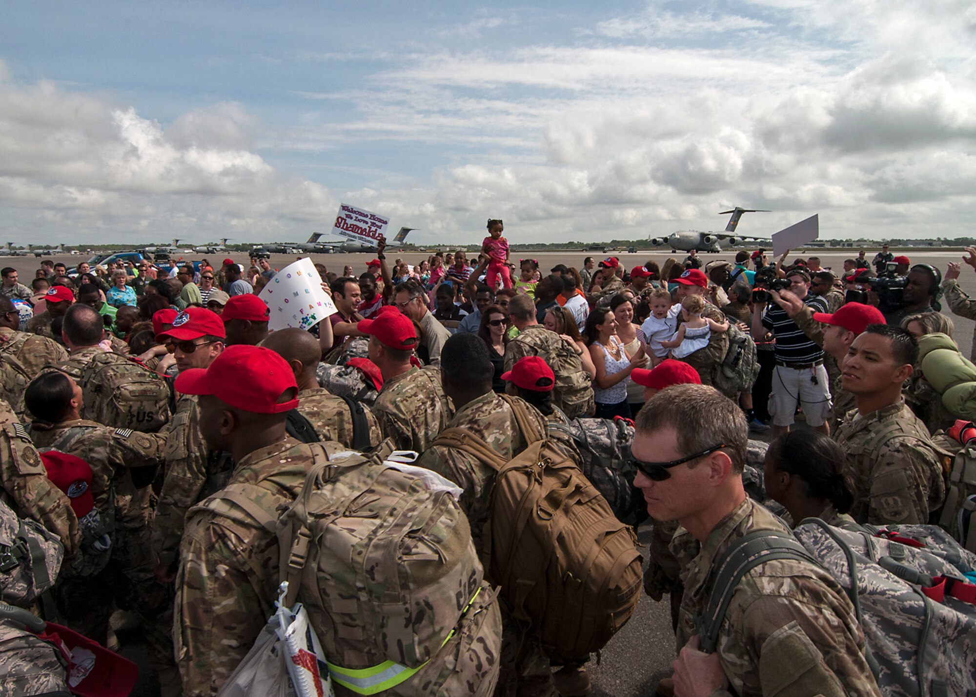 It didn't take long for the sea of red hats to wash over the hundreds of eagerly awaiting family and friends. Over 100 members of the 560th Red Horse Squadron here at Joint Base Charleston returned April 11 from a six-month deployment to the Southwest Asia region. (U.S. Air Force Reserve photo by Michael Dukes)