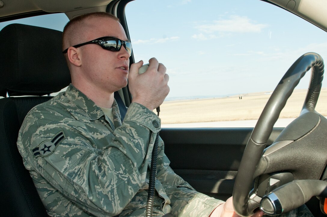 Airman 1st Class Steven Singleton, 28th Operation Support Squadron airfield management specialist, notifies the air traffic control tower while leaving the active runway on Ellsworth Air Force Base, S.D., April 4, 2013. Airfield Management Airmen are responsible for maintaining and managing all airfield movement and air traffic procedures. (U.S. Air Force photo by Airman 1st Class Kate Thornton-Maurer/Released)  
